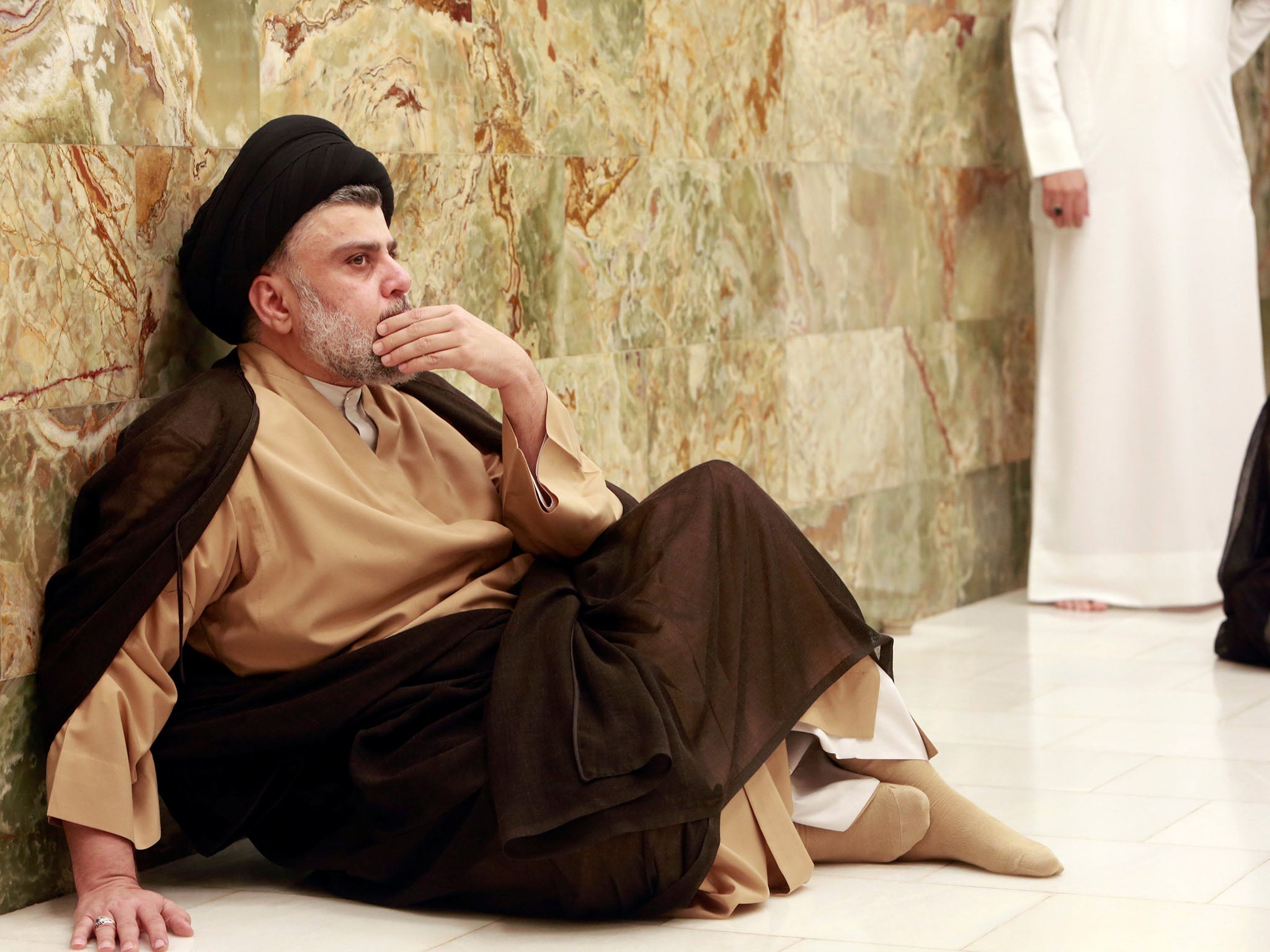 Iraqi Shia cleric Muqtada al-Sadr visits his father's grave after parliamentary election results were announced, in Najaf