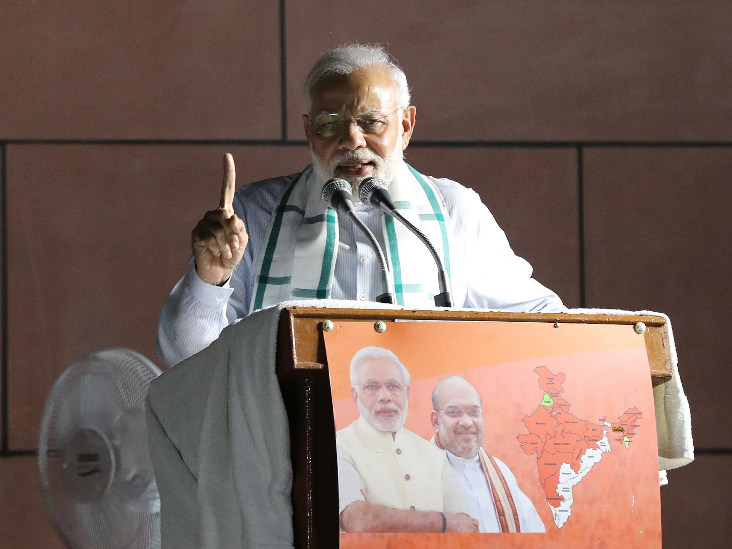 Indian Prime Minister Narendra Modi addresses party workers after the BJP won the highest number of seats in the Karnataka state elections