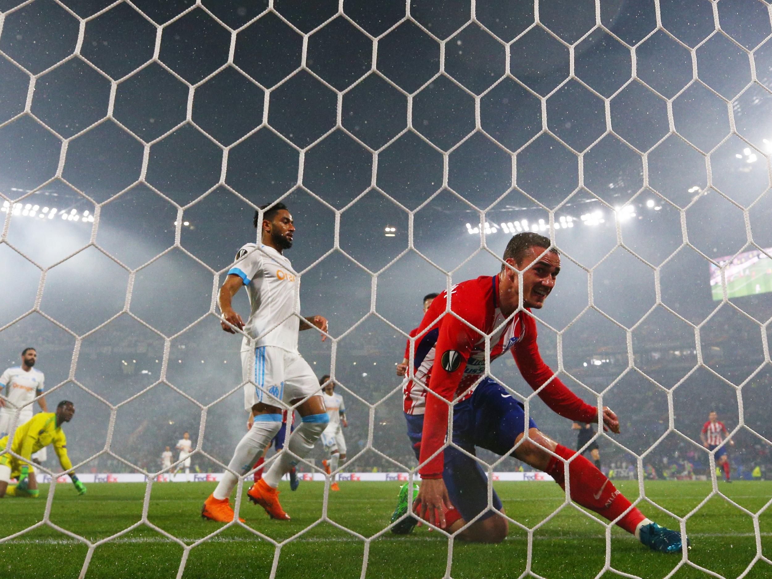 Griezmann reacts to the ball hitting the net