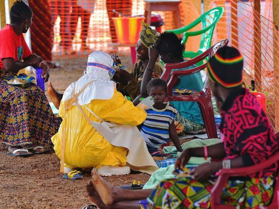 A health worker in West Africa attends to a suspected Ebola patient