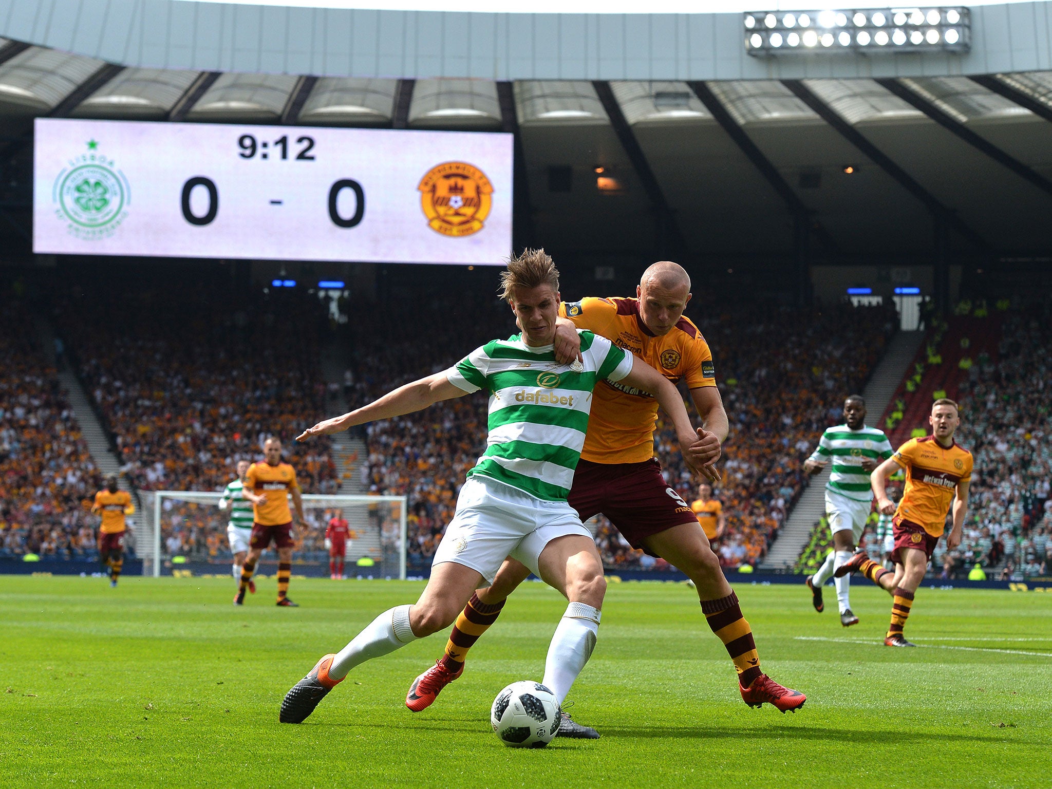 Kristoffer Ajer is challenged by Curtis Main