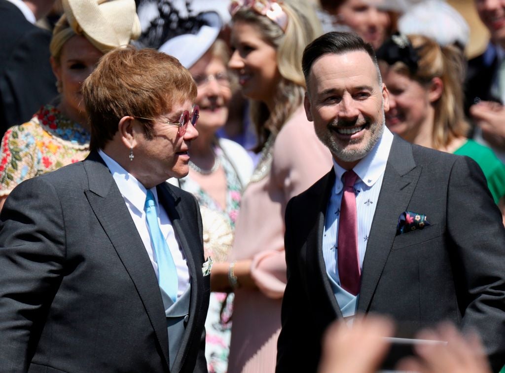 Sir Elton John attends the wedding of Prince Harry and Meghan Markle with his husband David Furnish