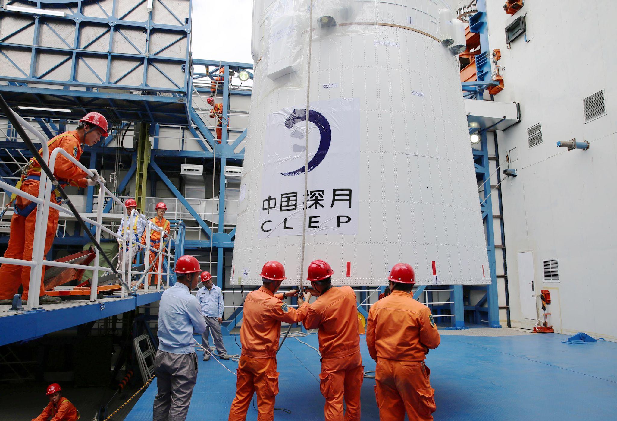 This undated picture released on May 21, 2018 shows employees loading the Queqiao ("Magpie Bridge") satellite at the Xichang launch centre in Xichang, China's southwestern Sichuan province