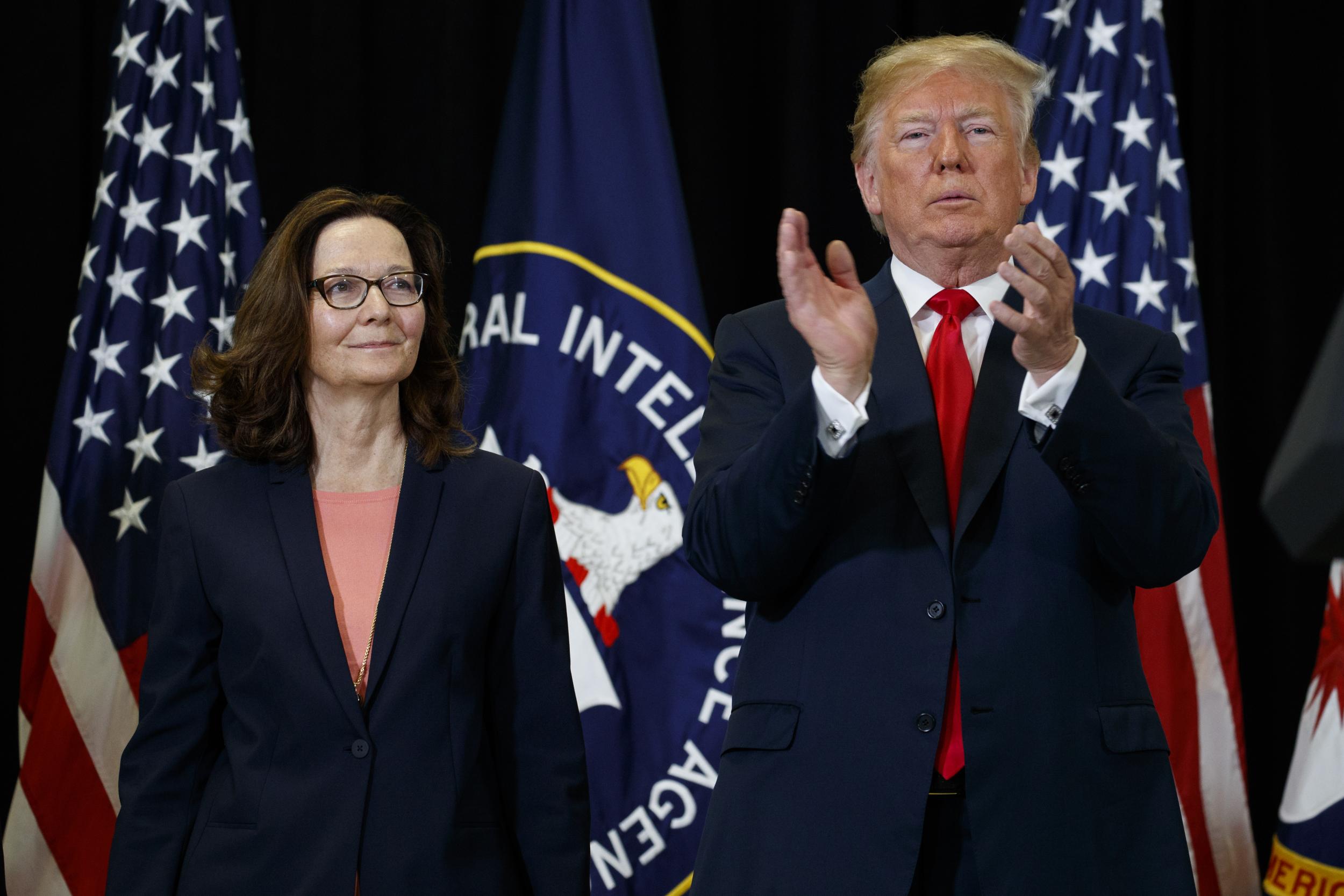 President Donald Trump applauds incoming Central Intelligence Agency director Gina Haspel during a swearing-in ceremony at CIA Headquarters, 21 May 2018, in Langley, Virginia.