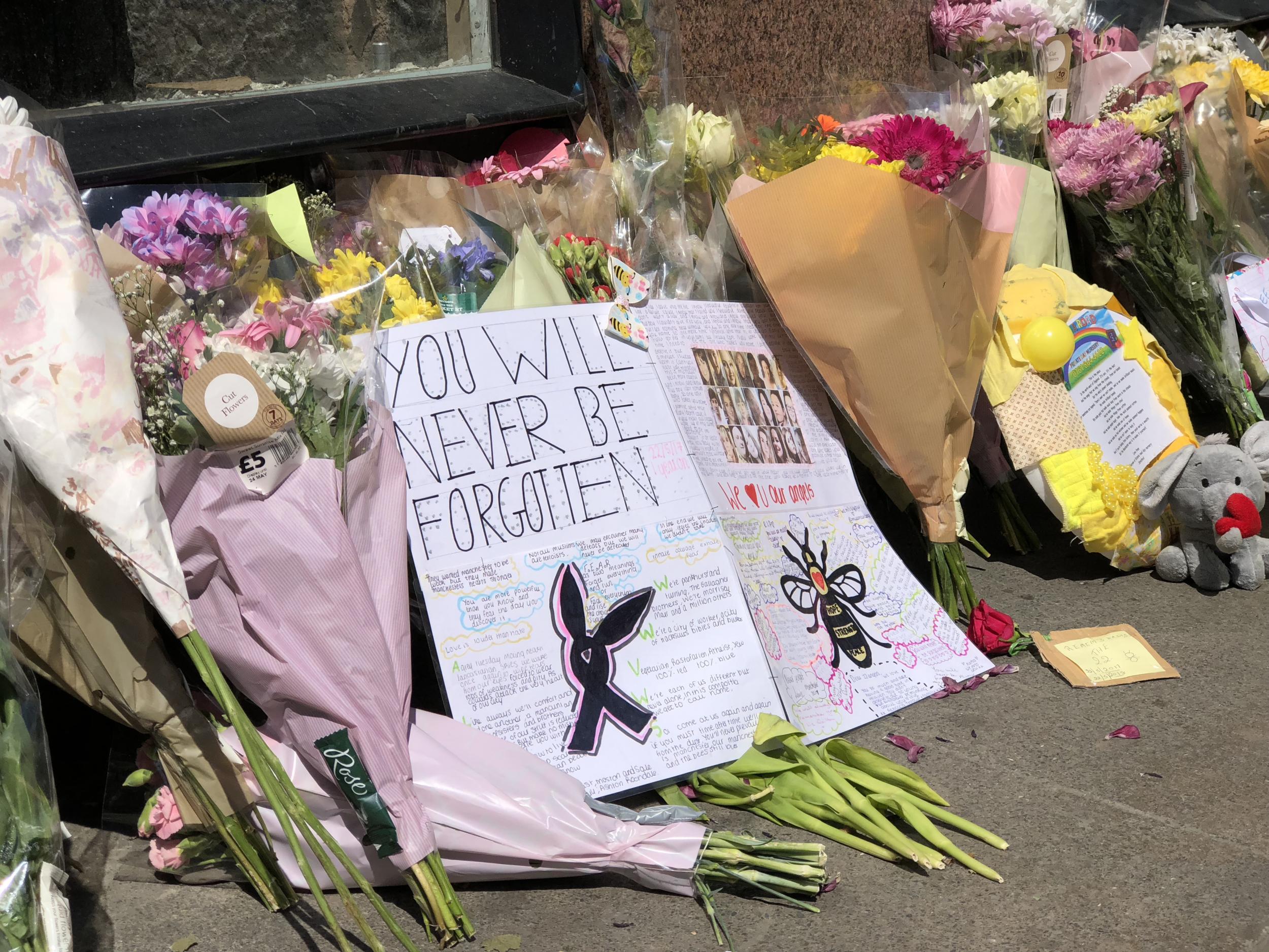 ‘You will never be forgotten’, reads a message left among the flowers