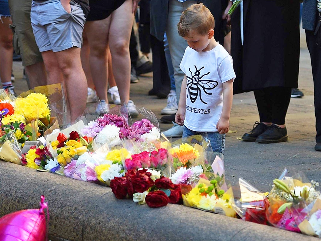 People paying their respects in central Manchester on the first anniversary of the attack