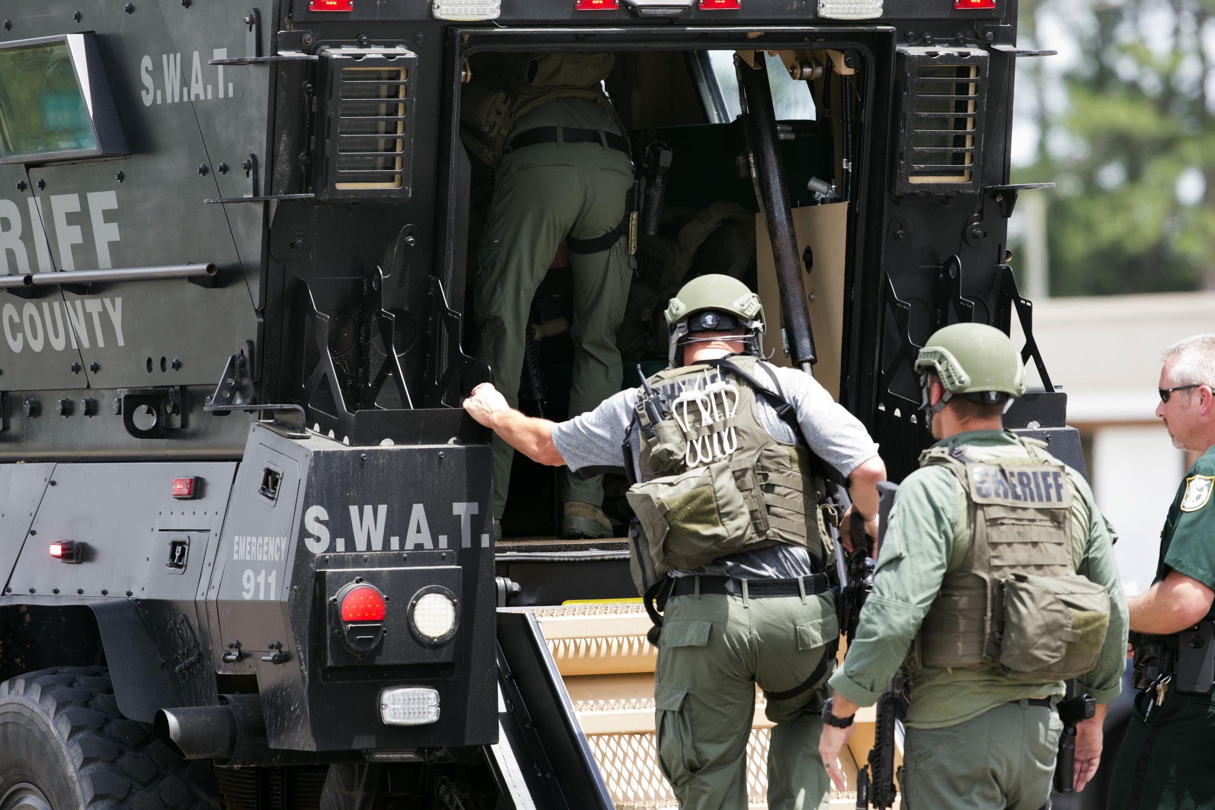 Bay County Sheriff's Office deputies enter an armored vehicle in response to an active shooter in the area