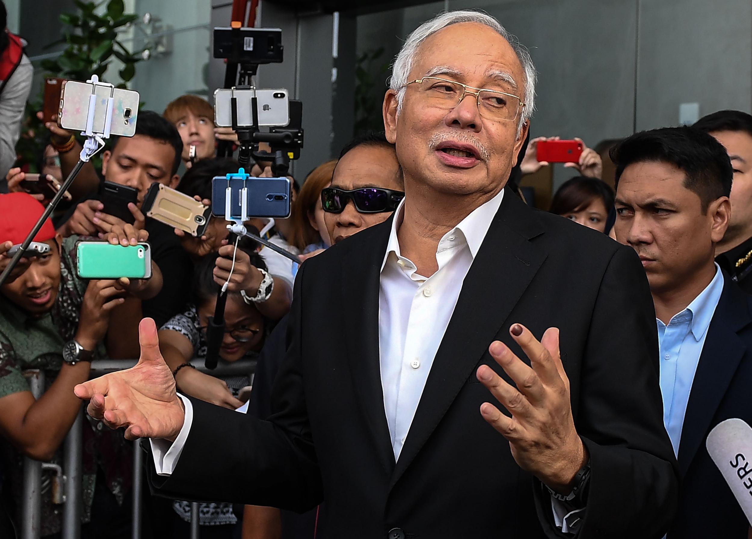 Malaysia's former prime minister Najib Razak speaks to the media after being questioned at the Malaysian Anti-Corruption Commission (MACC) office in Putrajaya