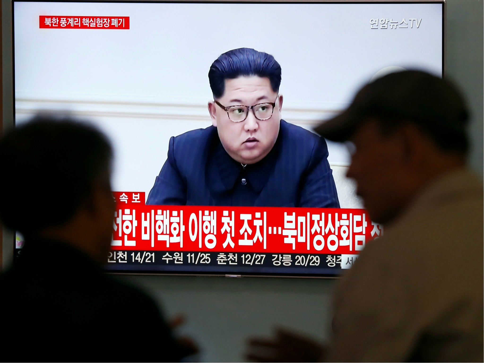 People watch a TV broadcasting a news report of North Korean leader Kim Jong-un, in Seoul, South Korea, 24 May 2018.