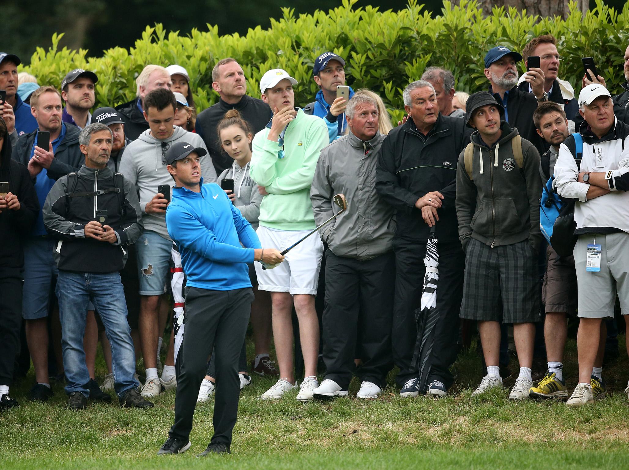 Rory McIlroy plays from the rough at the 17th