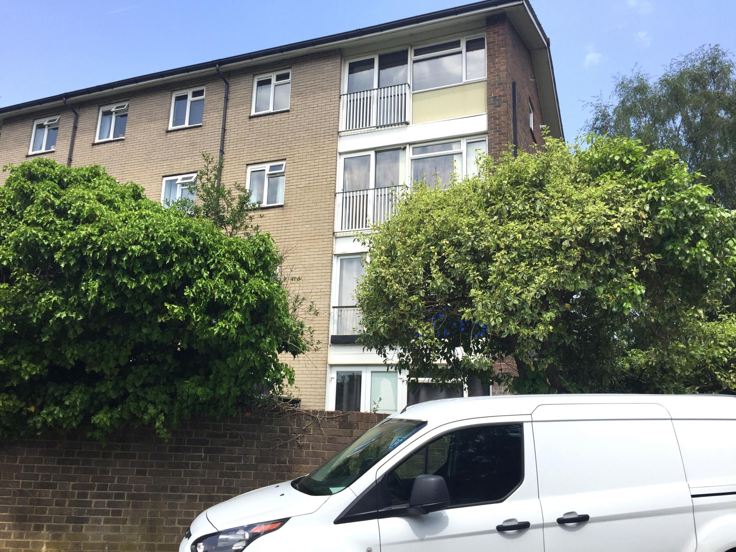 The scene in Highams Hill, Gossops Green, Crawley, West Sussex on Saturday after a woman in her 20s was found dead in a bed in a flat