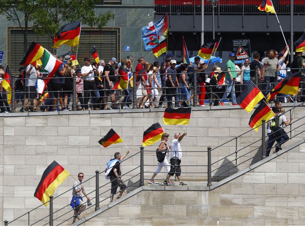 AfD sympathizers wave German flags and a WW2 German War Flag during the Right Party AfD demonstration march titled "Future Germany" on 27 May