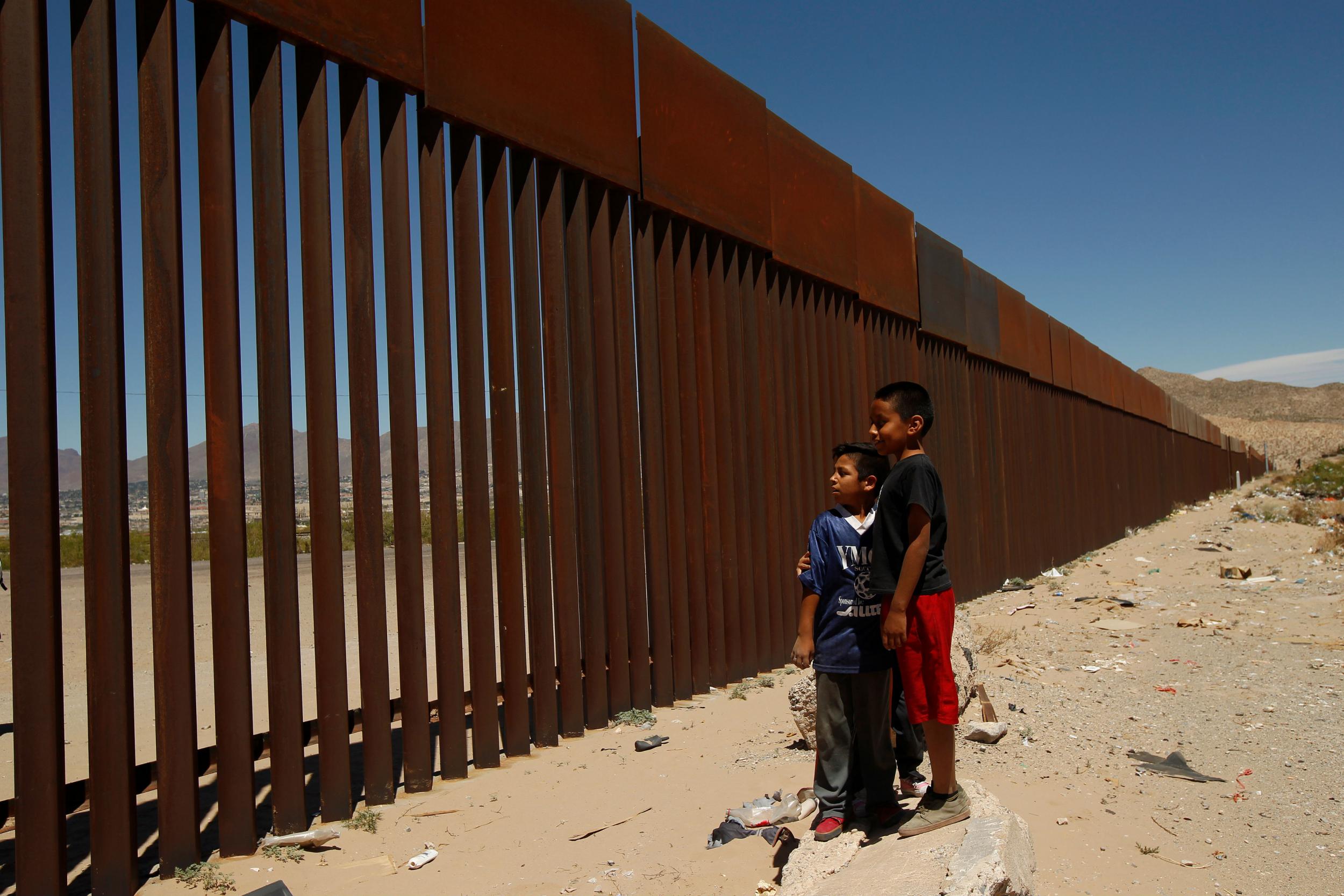 Children stand by a new section of the border wall on the U.S.-Mexico border in this picture taken from Anapra neighborhood in Ciudad Juarez, Mexico May 3, 2018.