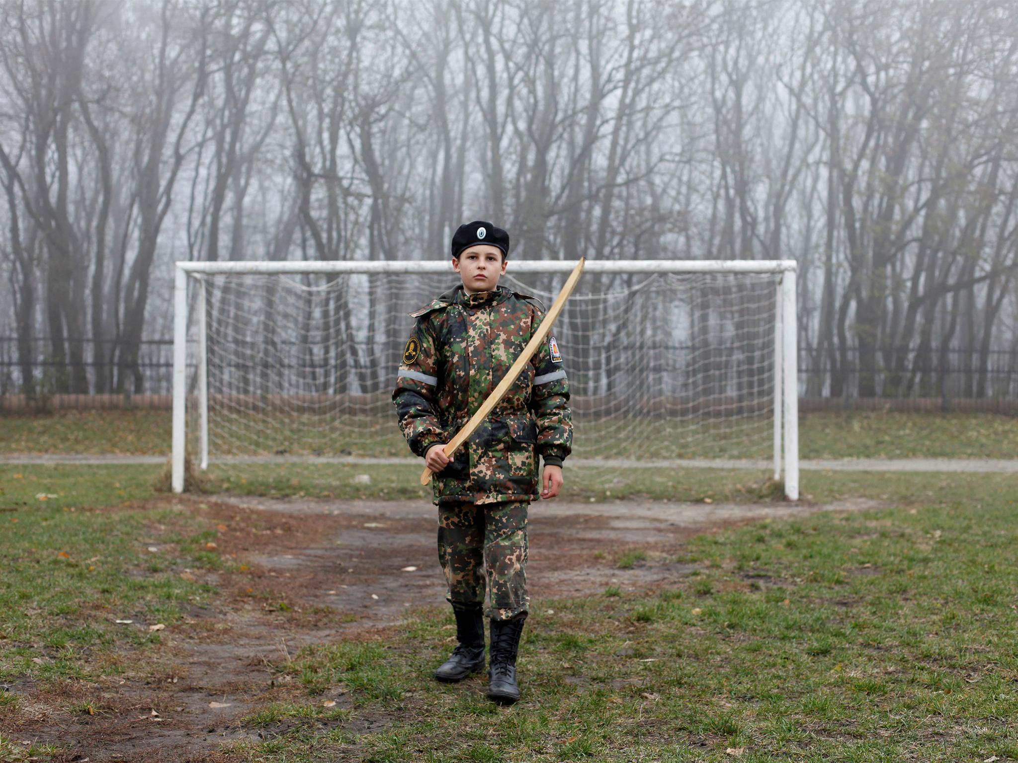 A cadet holds a model of a sword as he trains at the stadium of the General Yermolov Cadet School in Stavropol, Russia