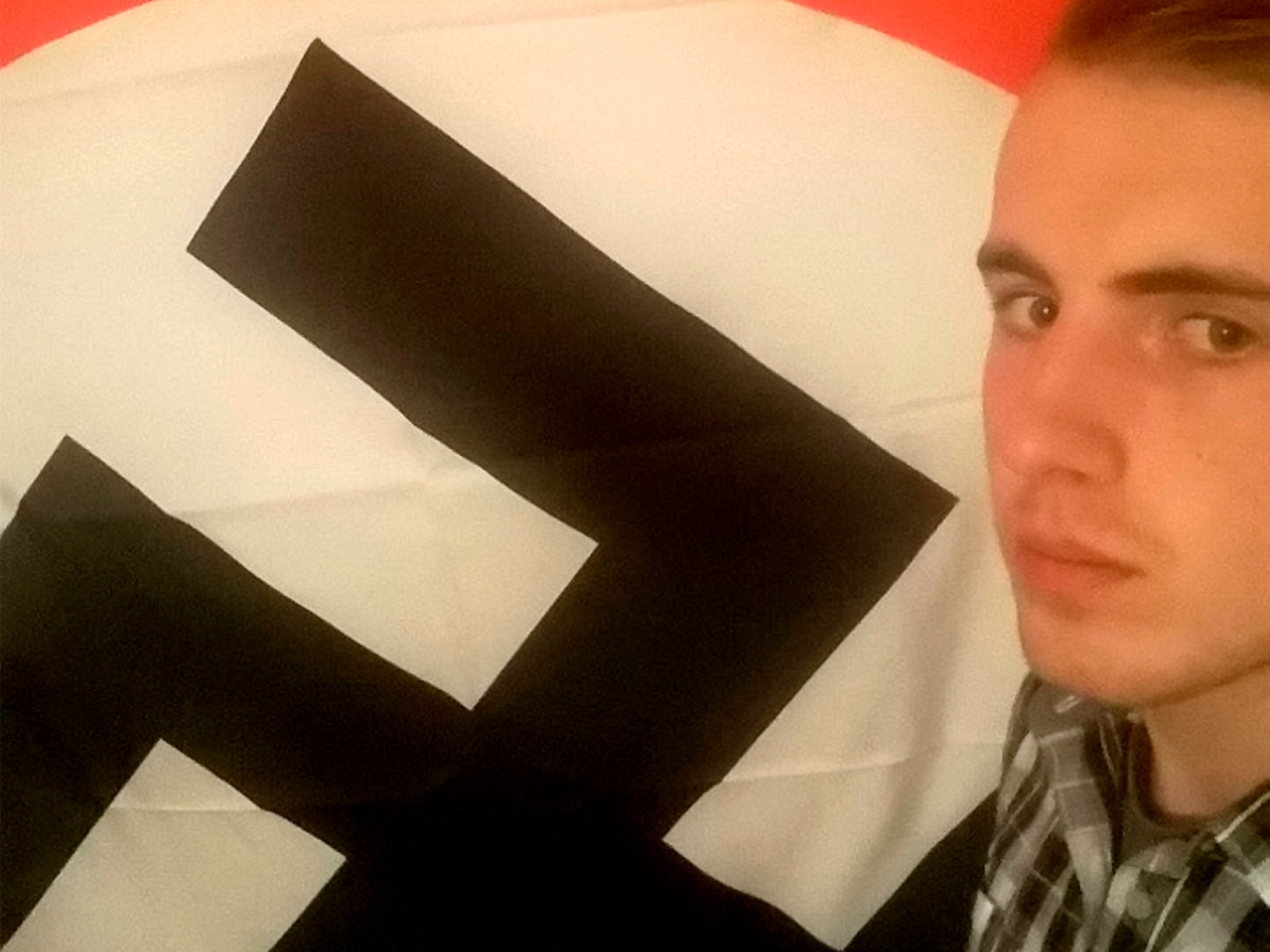 Ethan Stables poses next to a swastika, before his planned attack