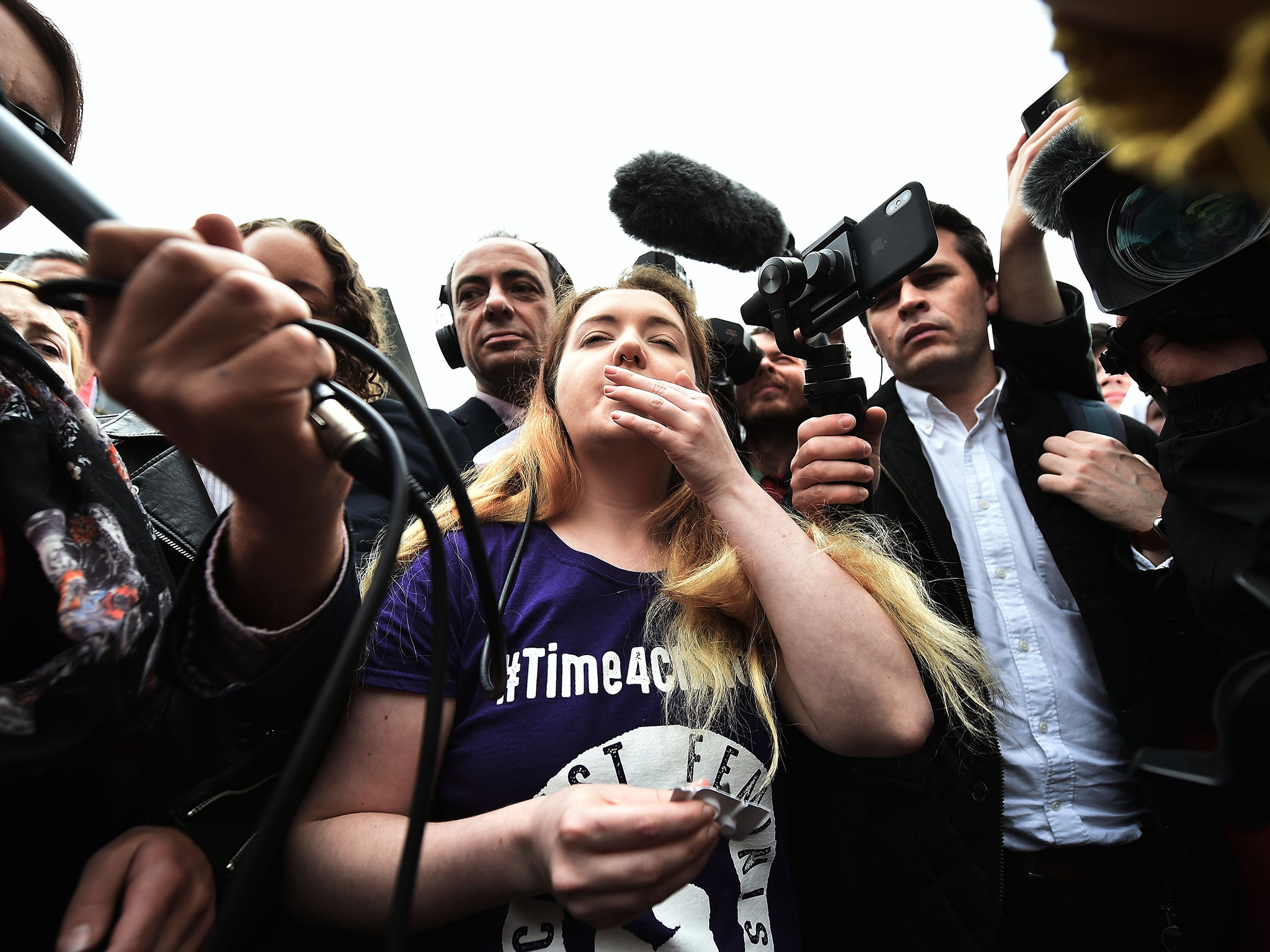 Eleanor Crossey Malone takes a pill at the protest