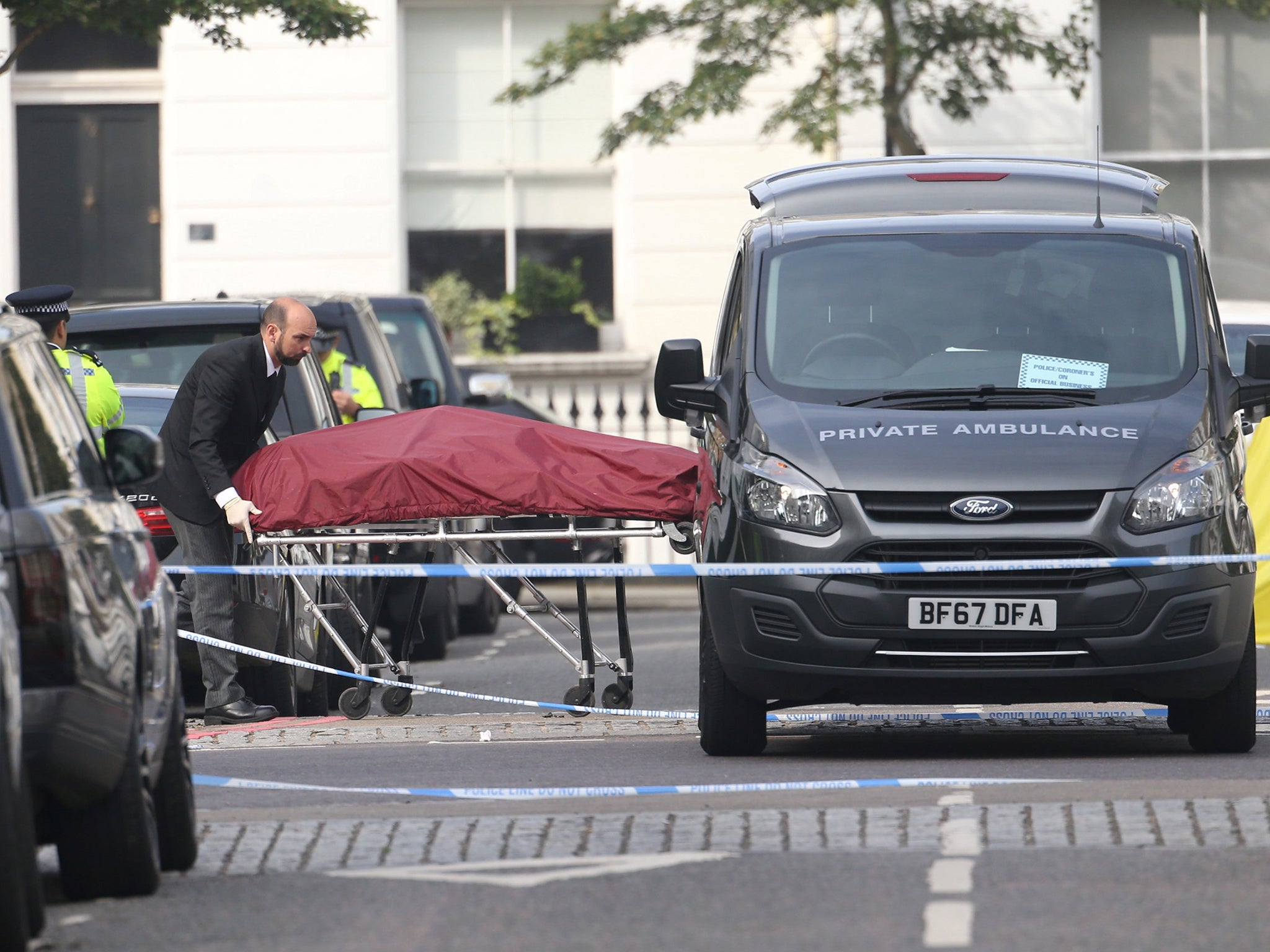 The victim's body is removed from the scene