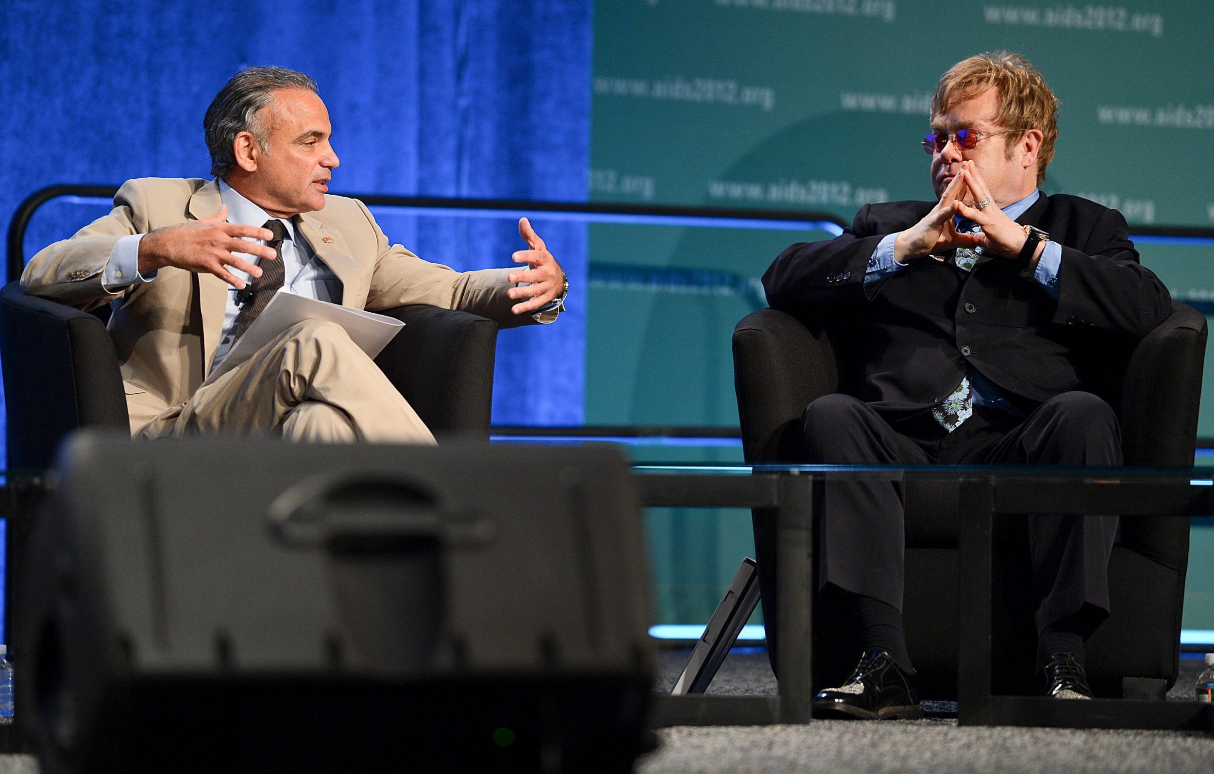 Luiz Loures (left) on stage with Sir Elton John at the 19th International Aids Conference in 2012