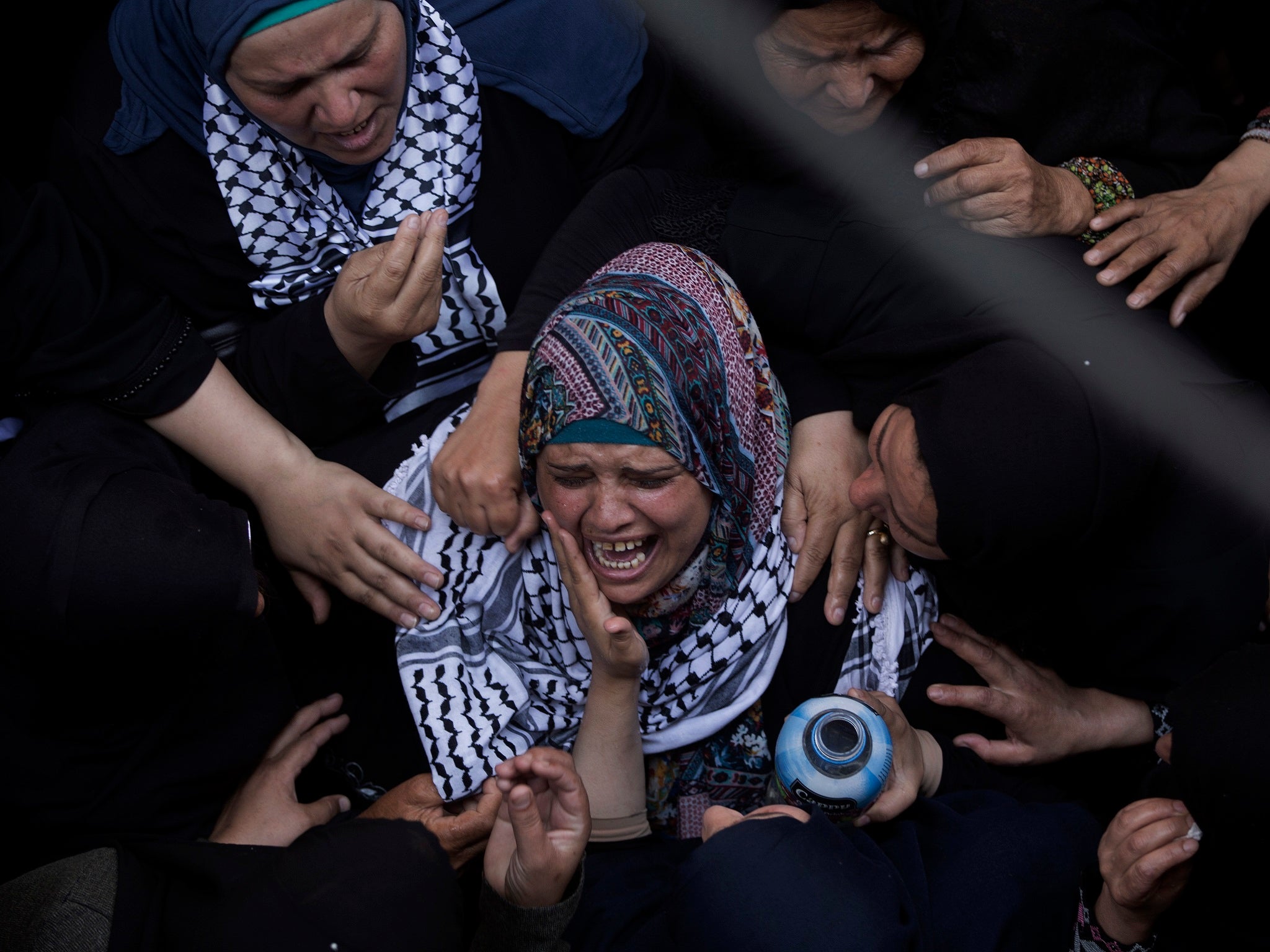 Relatives of Razan Najjar mourn at the family house during her funeral in town of Khan Younis, southern Gaza Strip