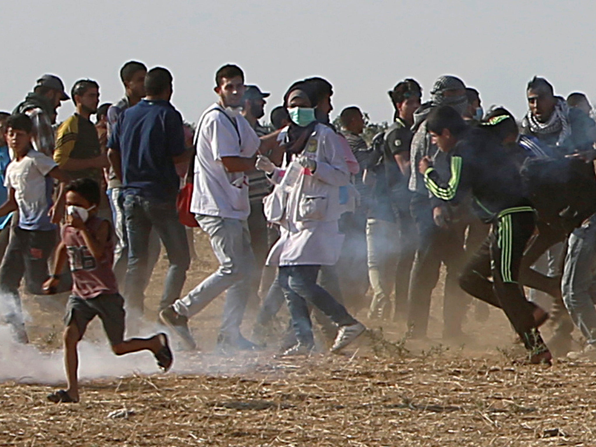 Ms Najjar (centre) is seen before being shot in her chest by Israeli troops while running with protesters to take cover from tear gas