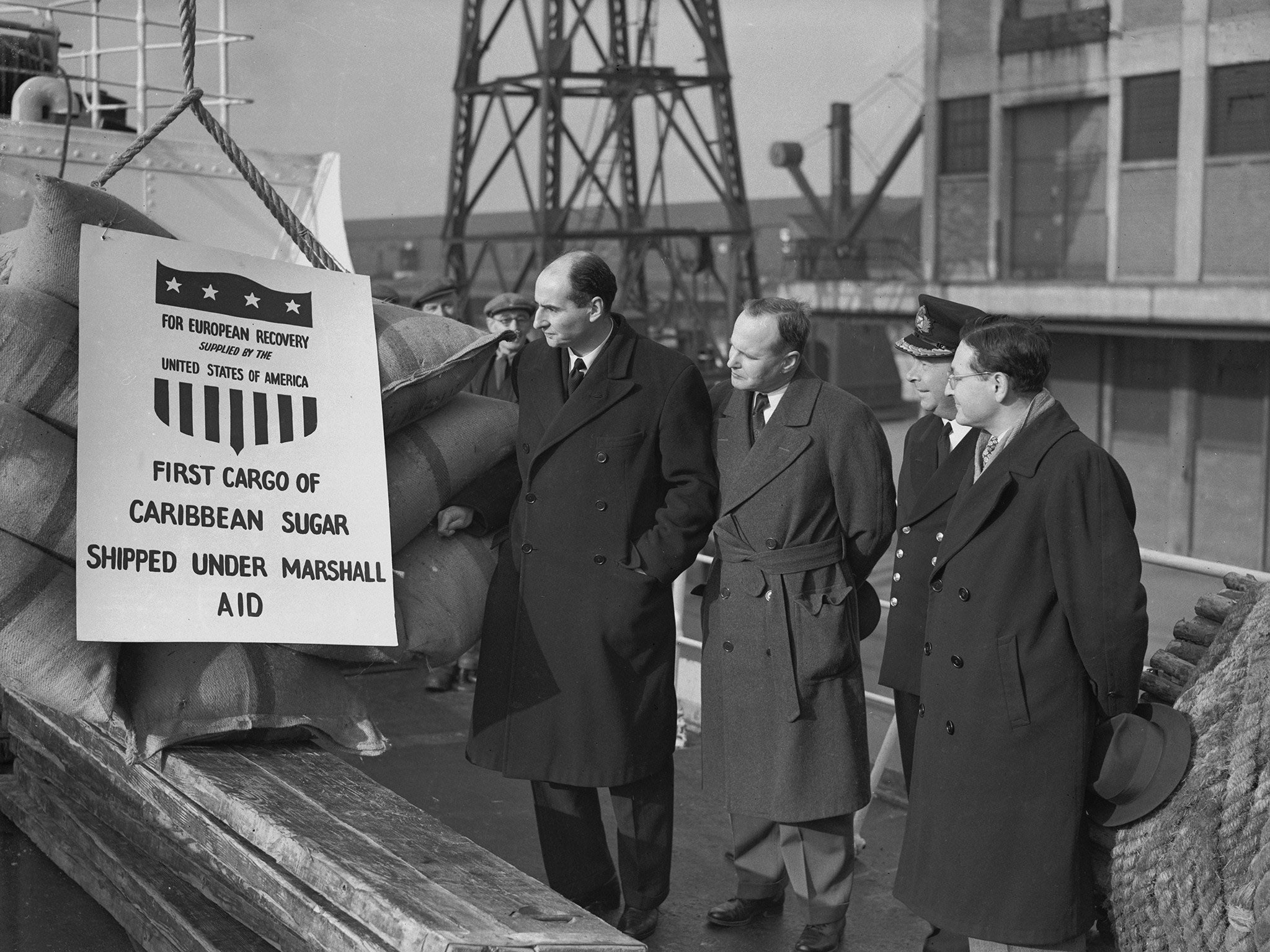 Dignitaries at the Royal Victoria Dock in London welcome the first shipment of Caribbean sugar made under the Marshall Plan of US aid for Europe