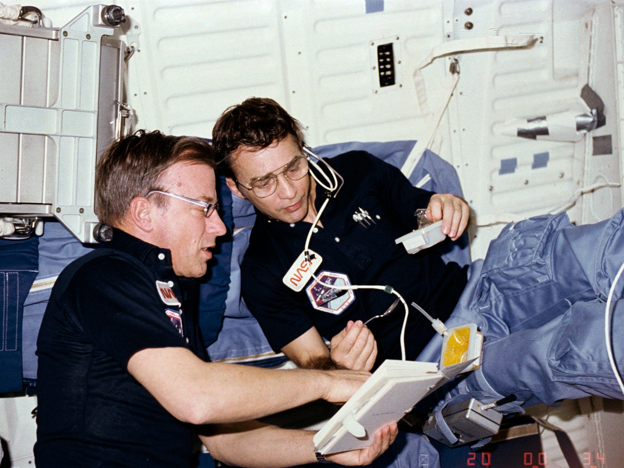 Peterson, right, aboard the space shuttle Challenger with fellow astronaut Paul J Weitz