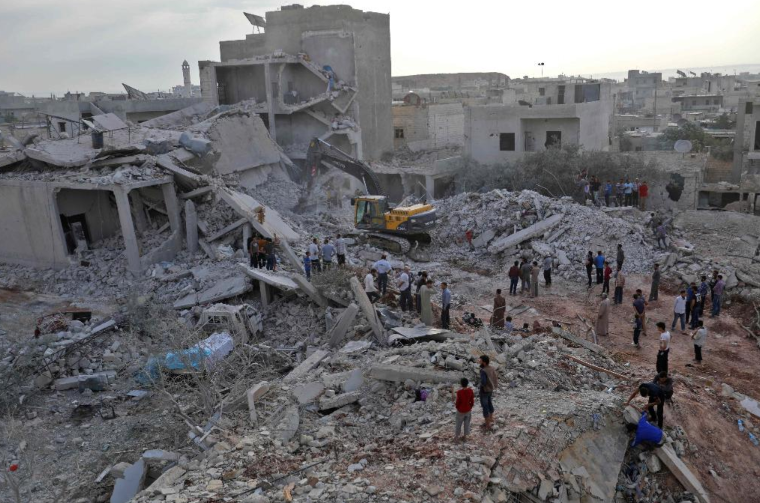 Villagers and rescue workers sift through the rubble searching for survivors after airstrikes hit the village of Zardana in Syria's Idlib province on 7 June 2018