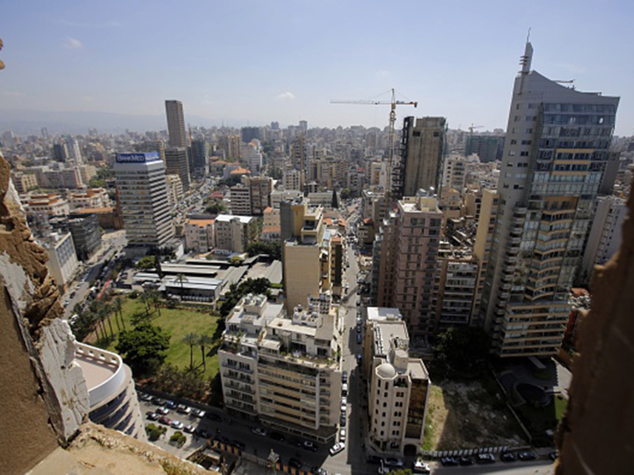 An area of West Beirut is seen through a window of the abandoned building of the Holiday Inn hotel