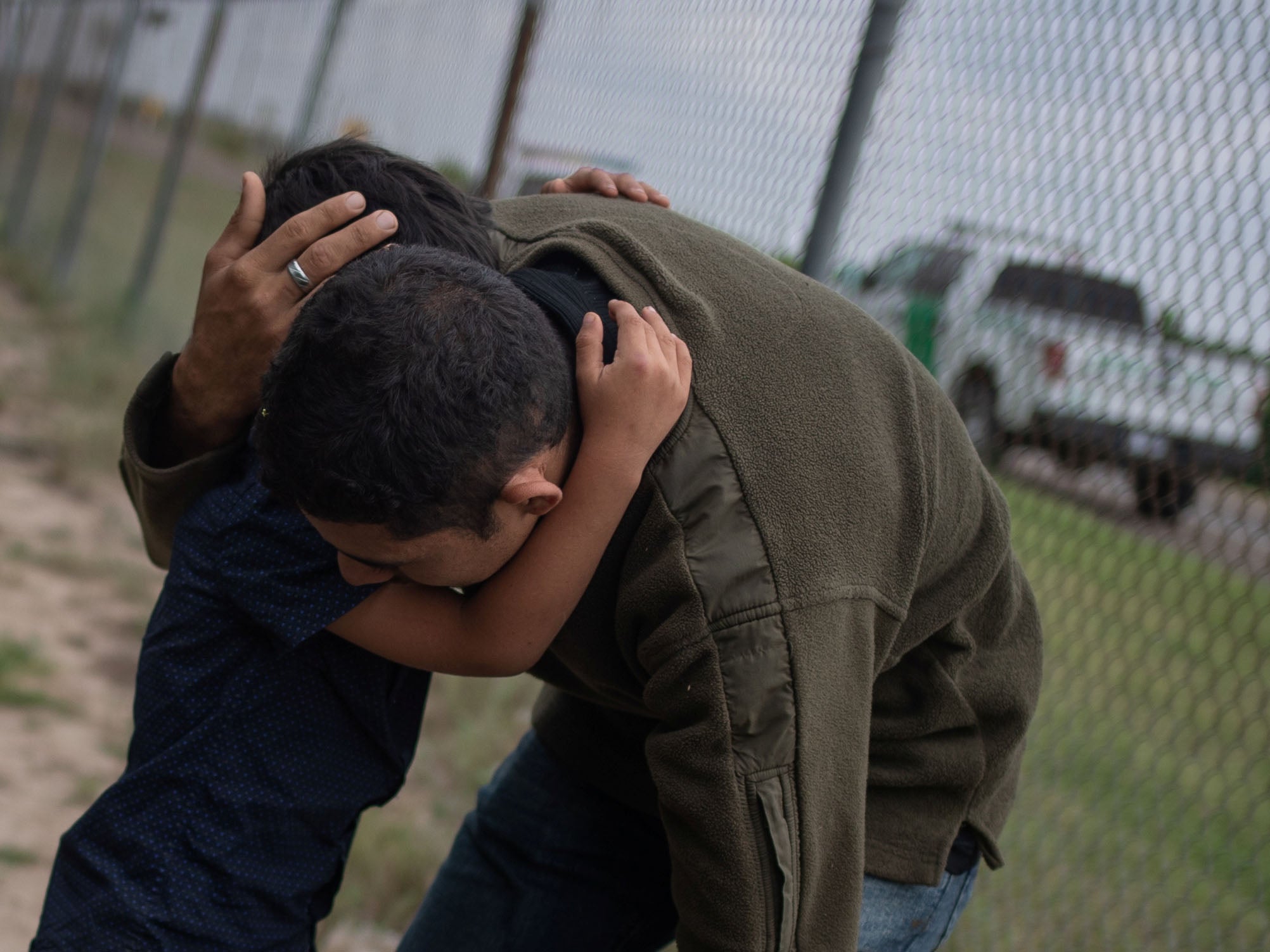 A four-year-old boy weeps in the arms of a family member as they were apprehended by border patrol agents after illegally crossing into the US border from Mexico on 2 May 2018.