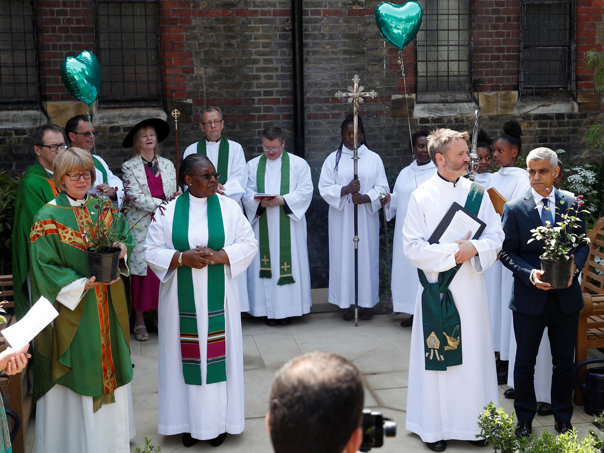 Sadiq Khan, joined by Bishop of London the Rt Rev Sarah Mullally, Bishop of Kensington the Rt Rev Graham Tomlin and other members of the congregation, plants a small shrub at the service