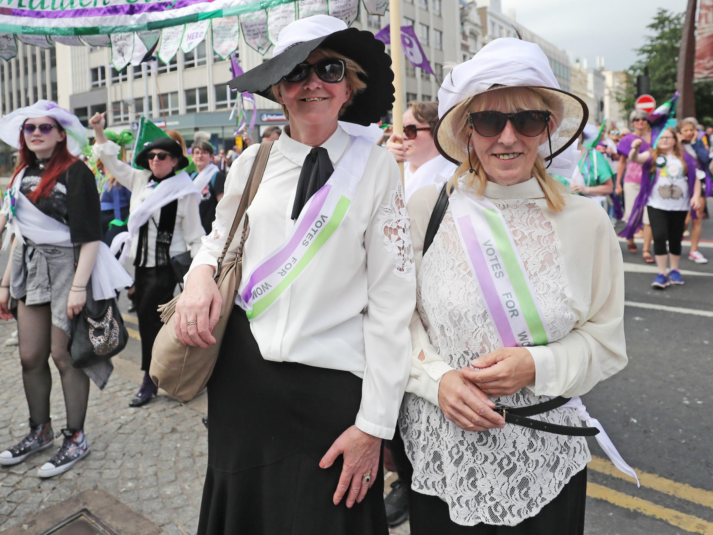 Women dressed as suffragettes take part in the Processions' artwork march, in Belfast, as they mark 100 years since the Representation of the People Act