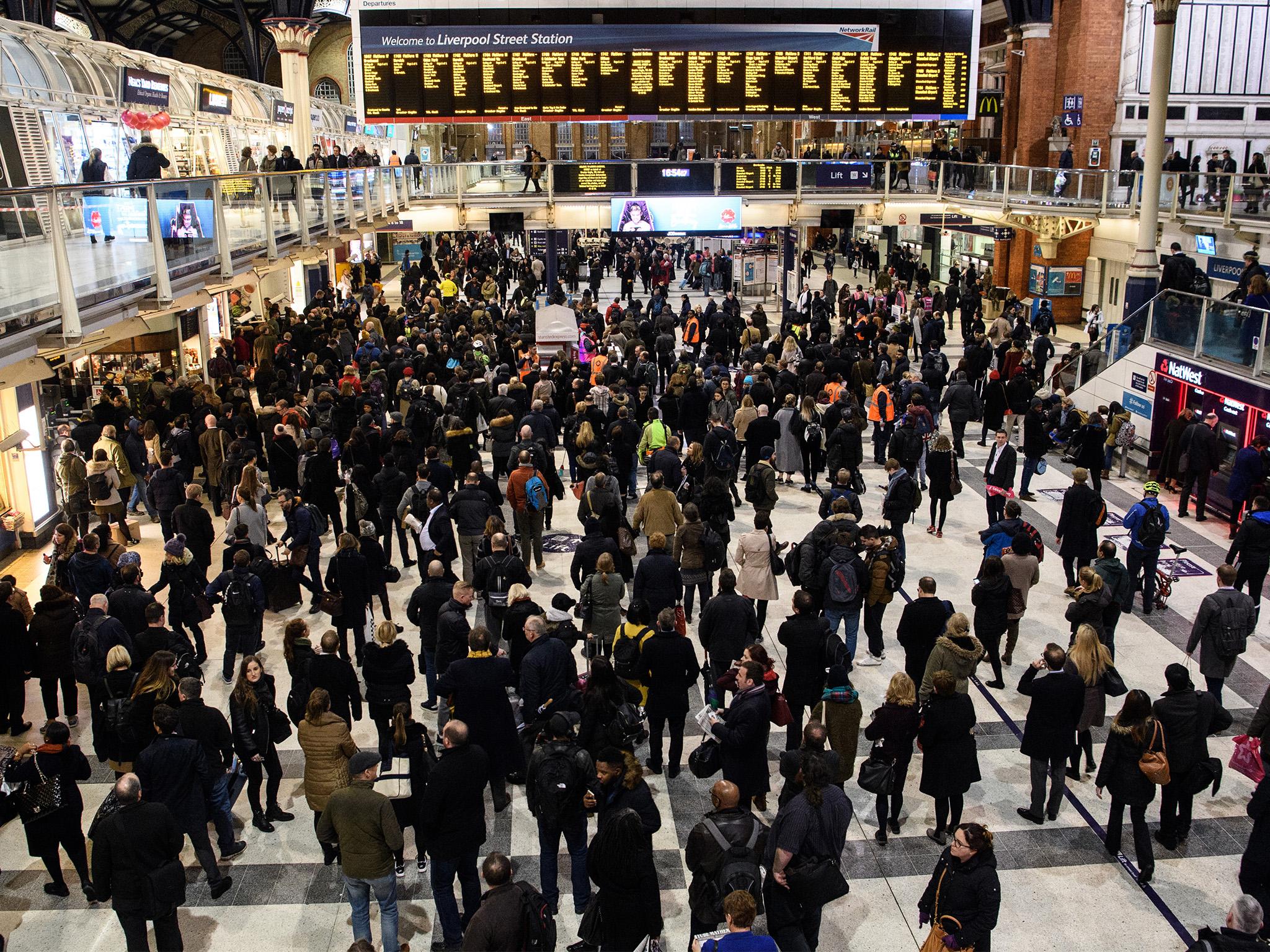 Commuters wait for trains at Liverpool Street station during travel disruption in 2017