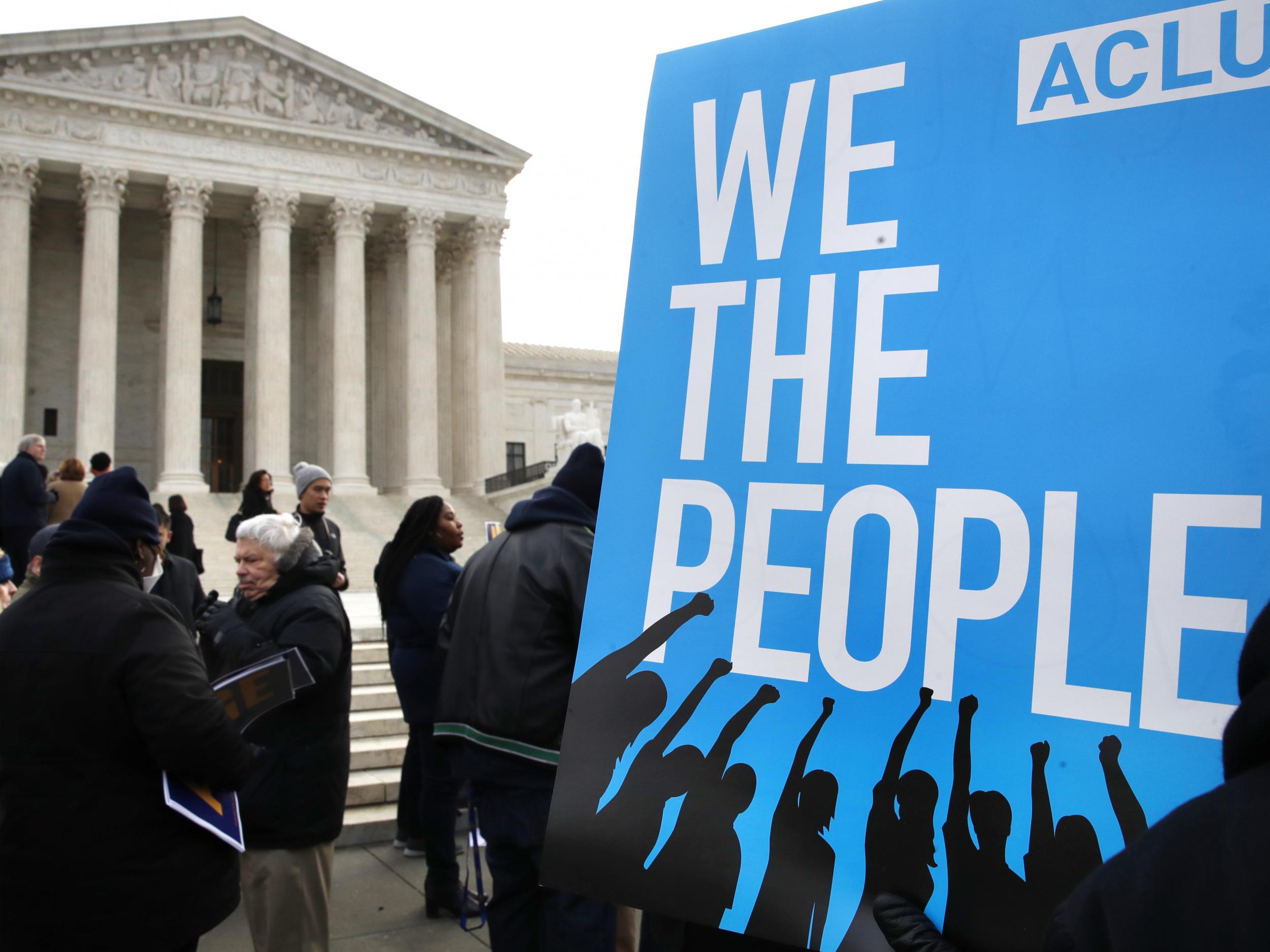 Protesters outside of the Supreme Court rally in opposition to Ohio's voter roll purges