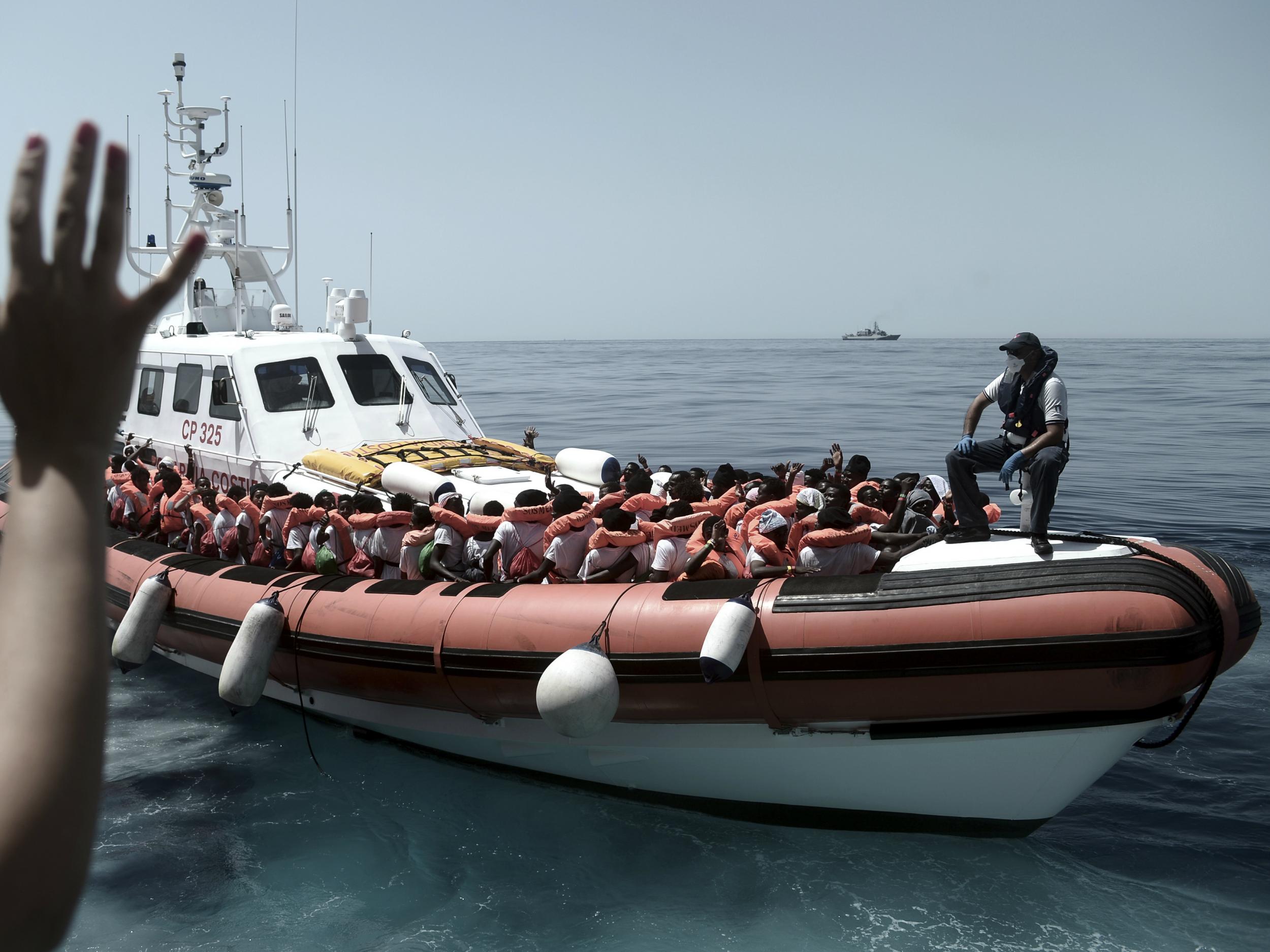 Migrants on an Italian Coast Guard boat are transferred from the Aquarius to Italian ships (AP/SOS Mediterranee)