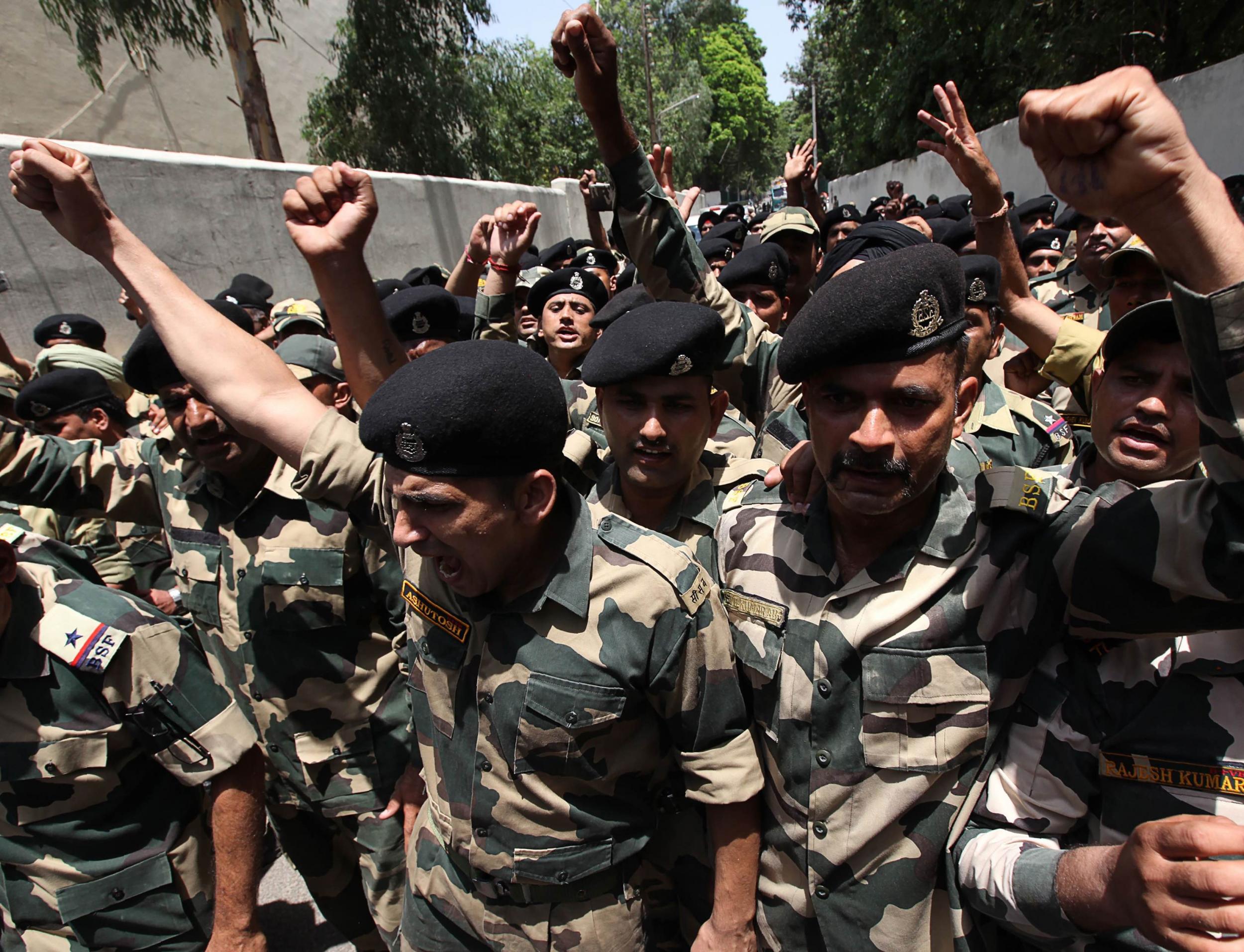 Indian border force soldiers shout anti-Pakistan and pro-India slogans during a wreath-laying ceremony in Jammu on Wednesday