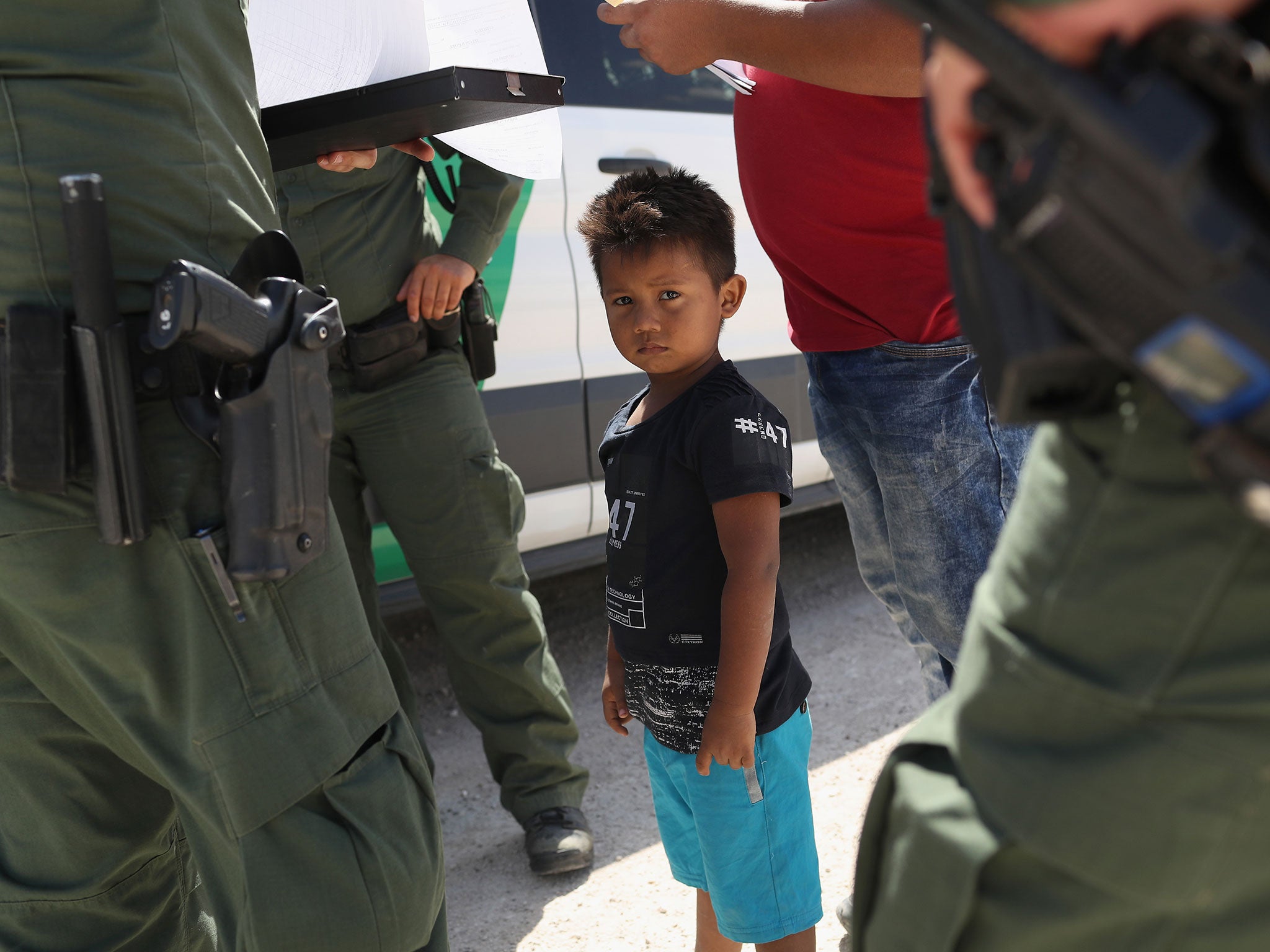 Child among Border Patrol agents at US border with Mexico