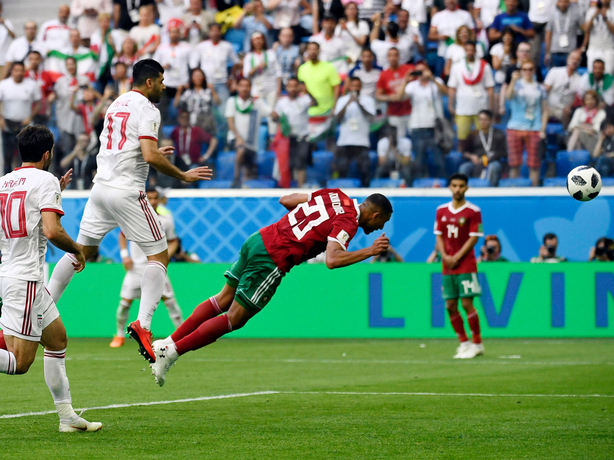 Morocco's forward Aziz Bouhaddouz scores an own goal