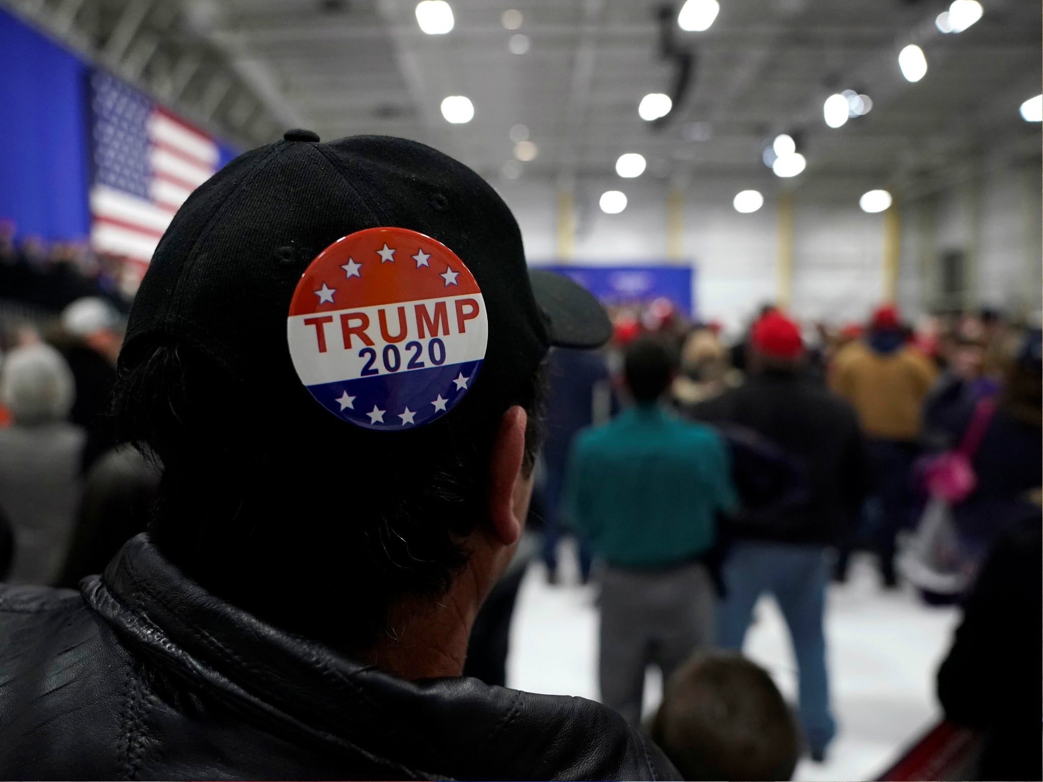 A man wears a Trump 2020 campaign button as US President Donald Trump speaks during a Make America Great Again rally in Pennsylvania, 10 March 2018.