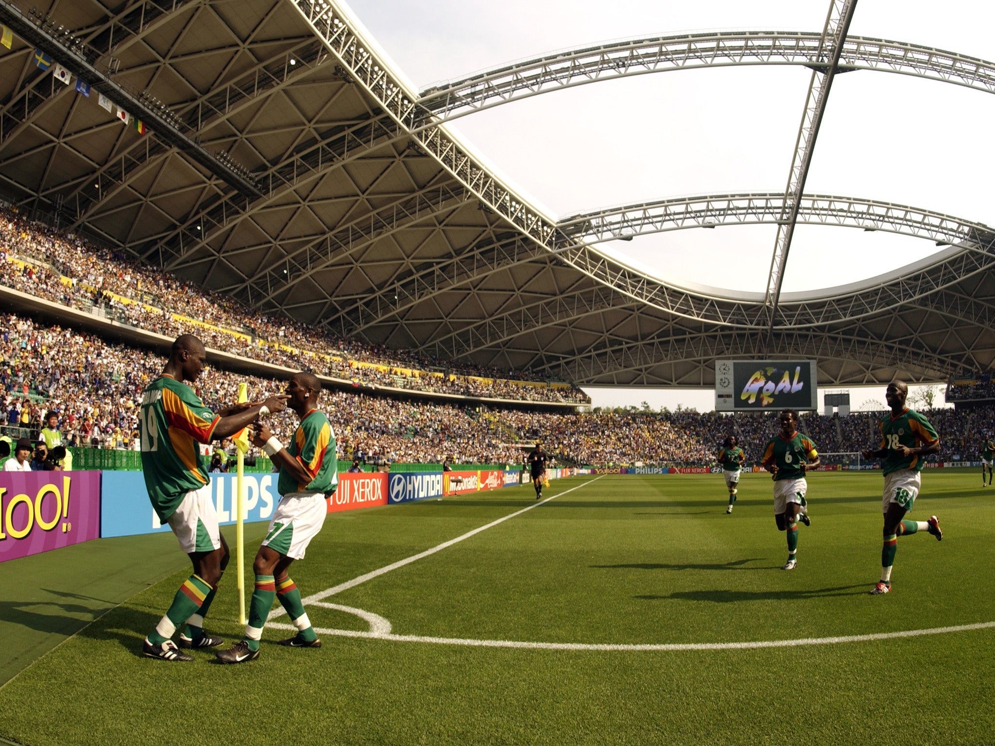 Senegal celebrate Henri Camara's goal against Sweden at the Oita Big Eye Stadium. Senegal won 2-1 after extra time