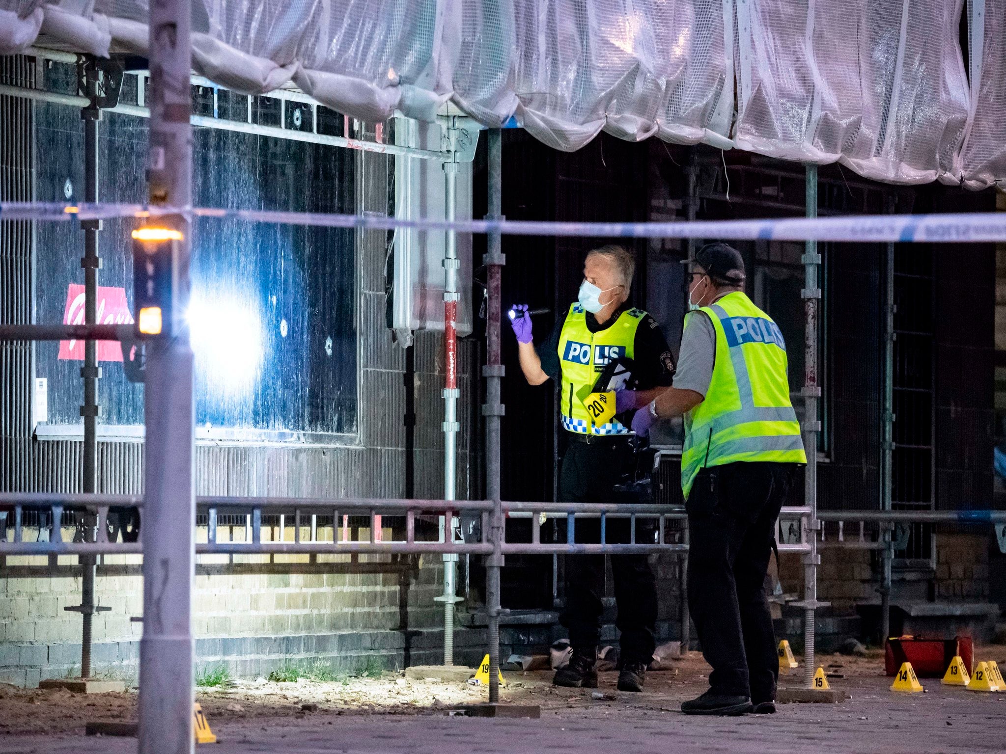 Policemen search the scene after a shooting in the Swedish city of Malmo