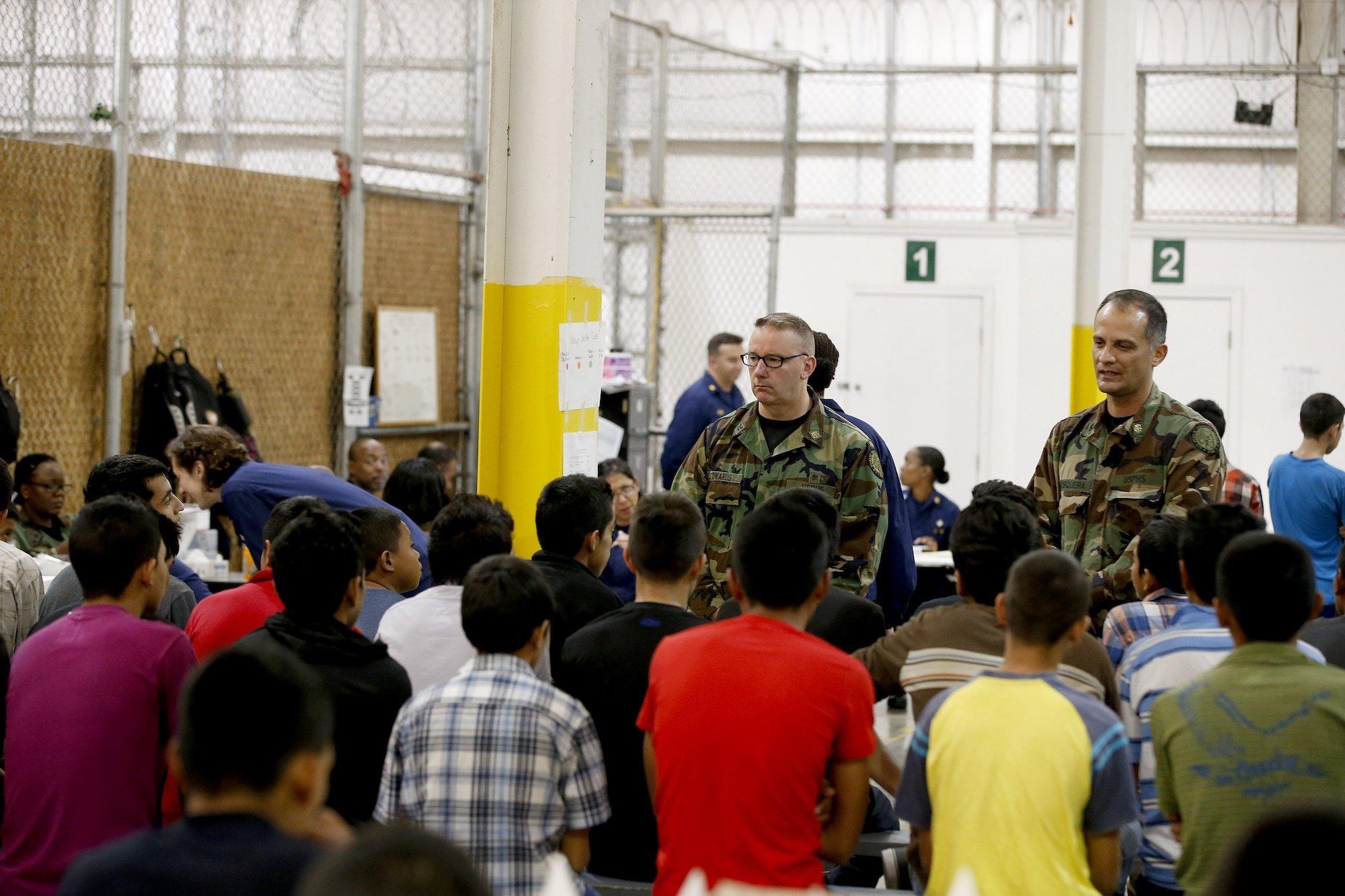 Detainees sleep and watch television in a holding cell where hundreds of mostly Central American immigrant children are being processed and held at the U.S. Customs and Border Protection Nogales Placement Center