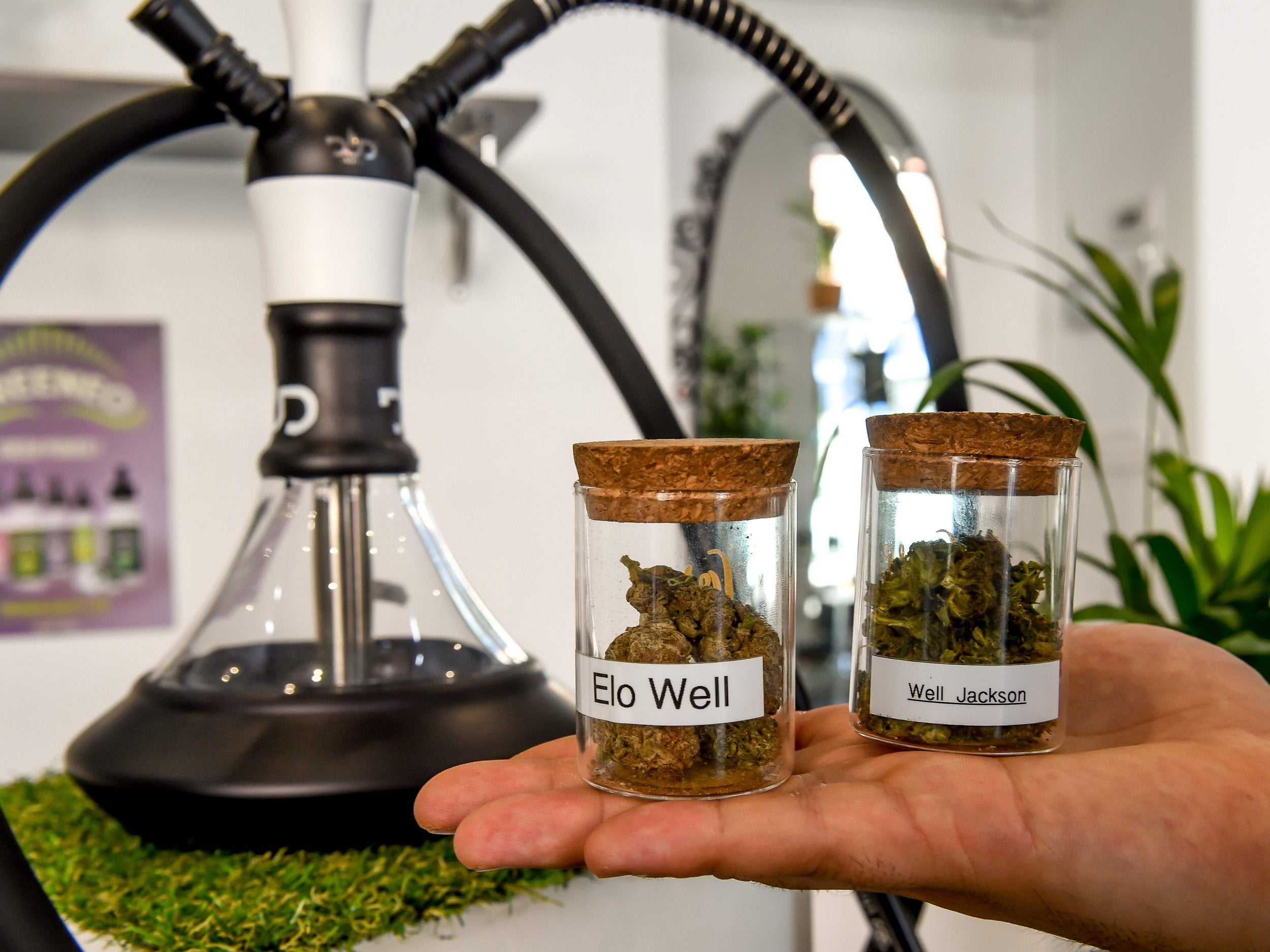 Vials containing strains of low-strength cannabis in a shop near Lille, northern France