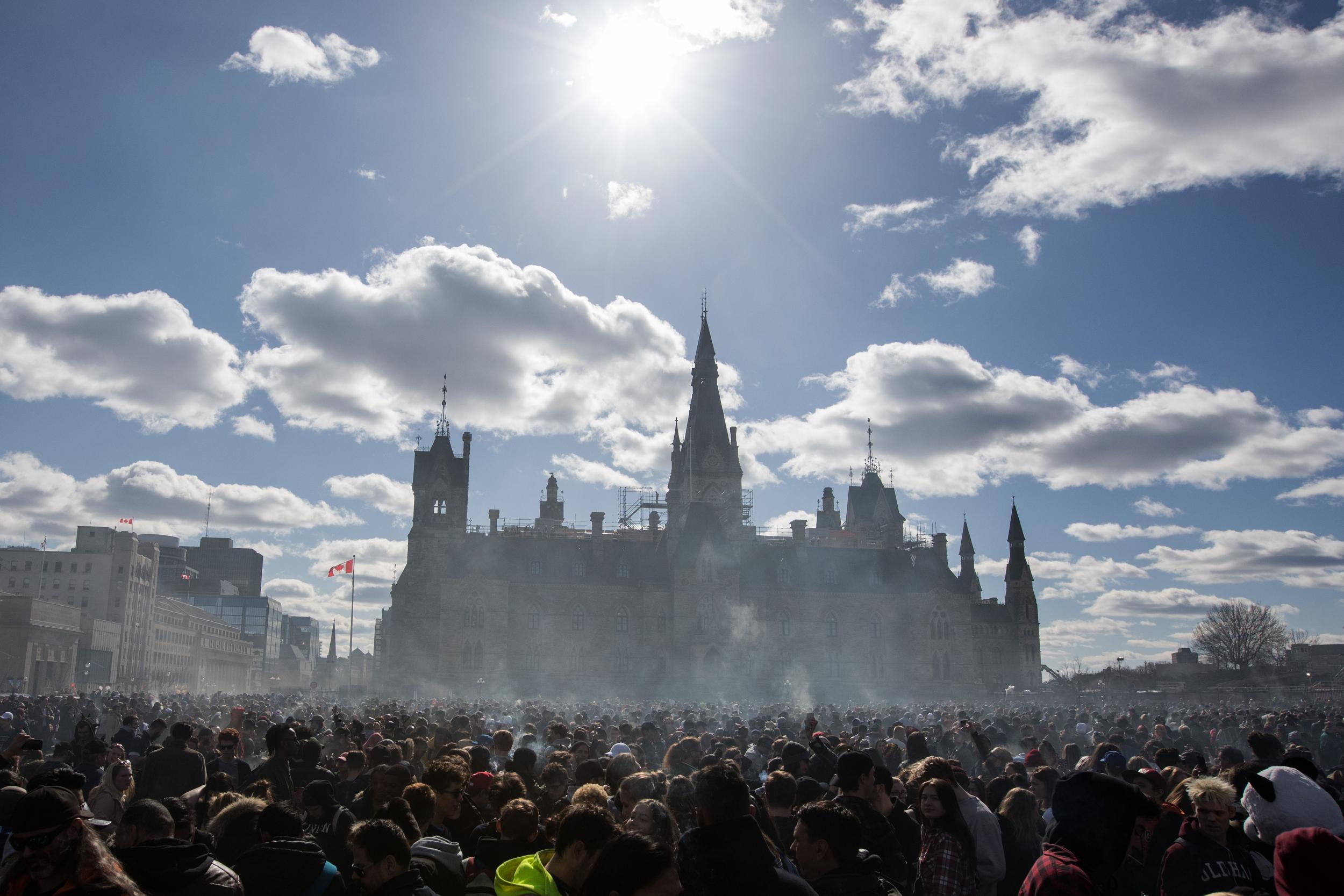 Smoke lingers over Parliament Hill as people smoke marijuana during the annual 4/20 rally on Parliament Hill in Ottawa, Ontario