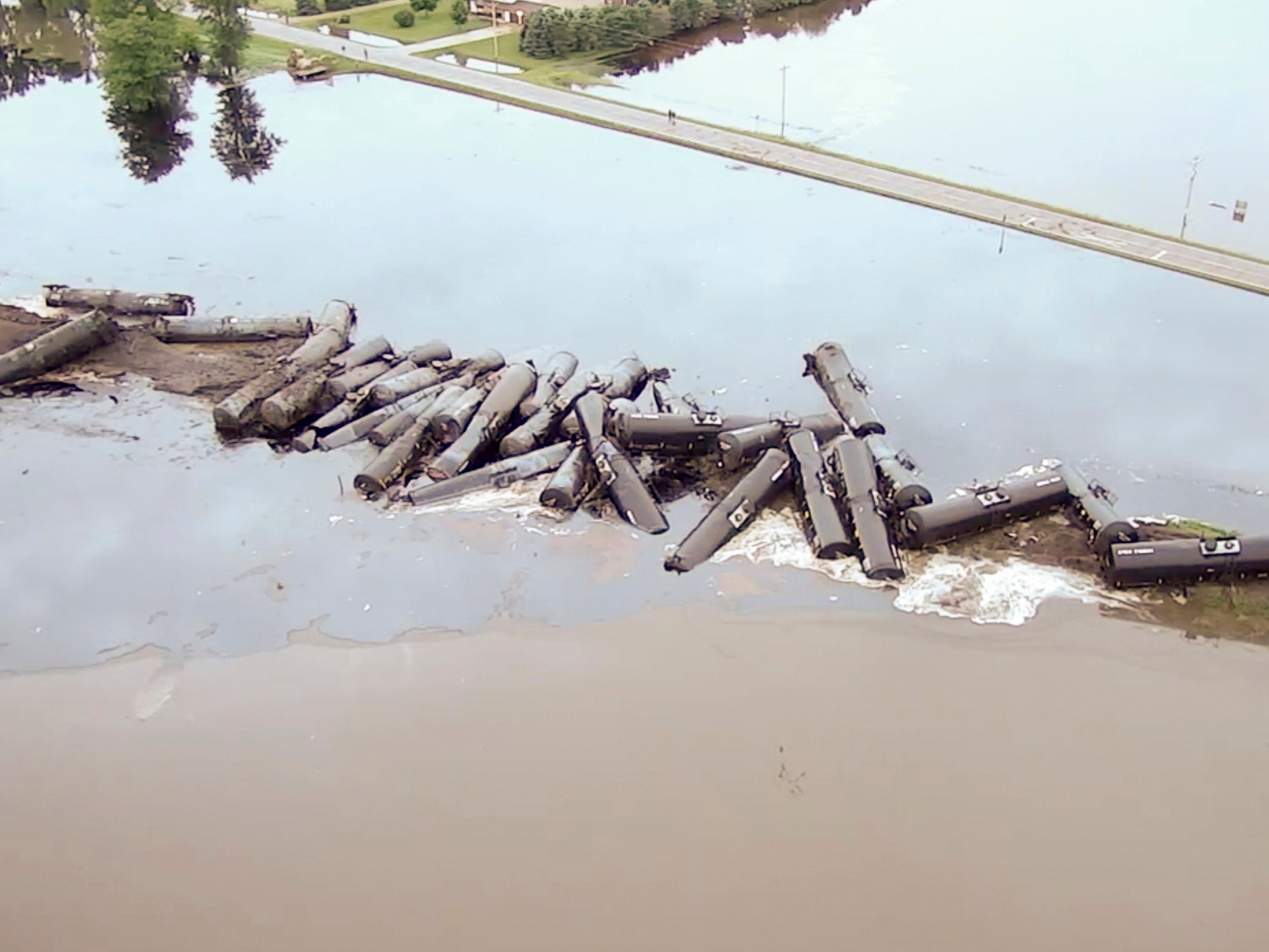 Tanker cars carrying crude oil are shown derailed about a mile south of Doon, Iowa