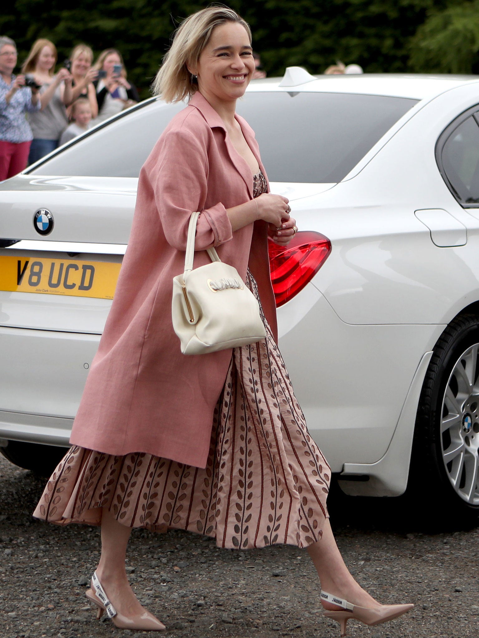 Emilia Clarke arrives at Rayne Church in Aberdeenshire for the wedding of Game of Thrones co-stars Kit Harington and Rose Leslie