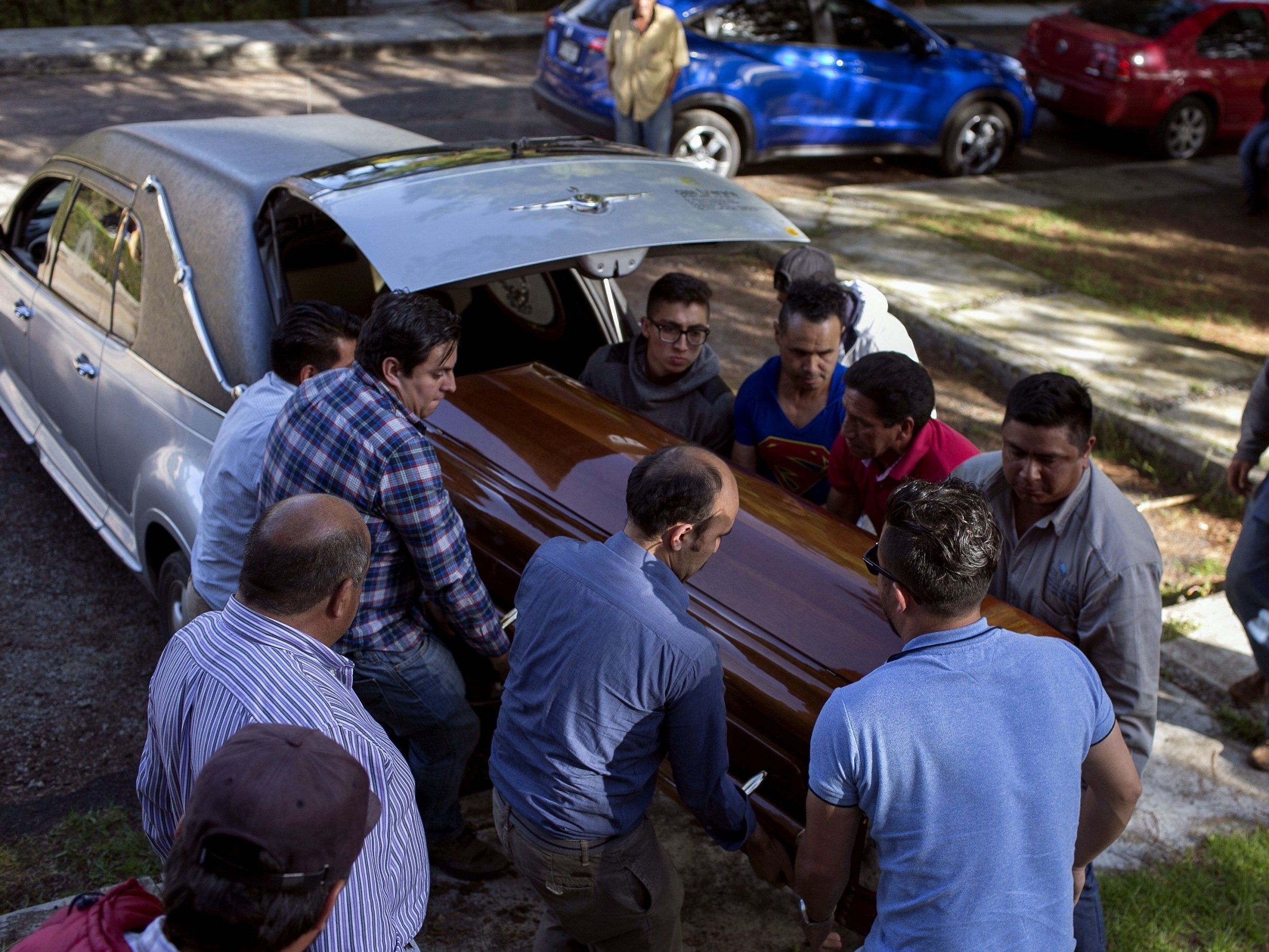 Relatives of Fernando Angeles Juarez carry the coffin at his funeral