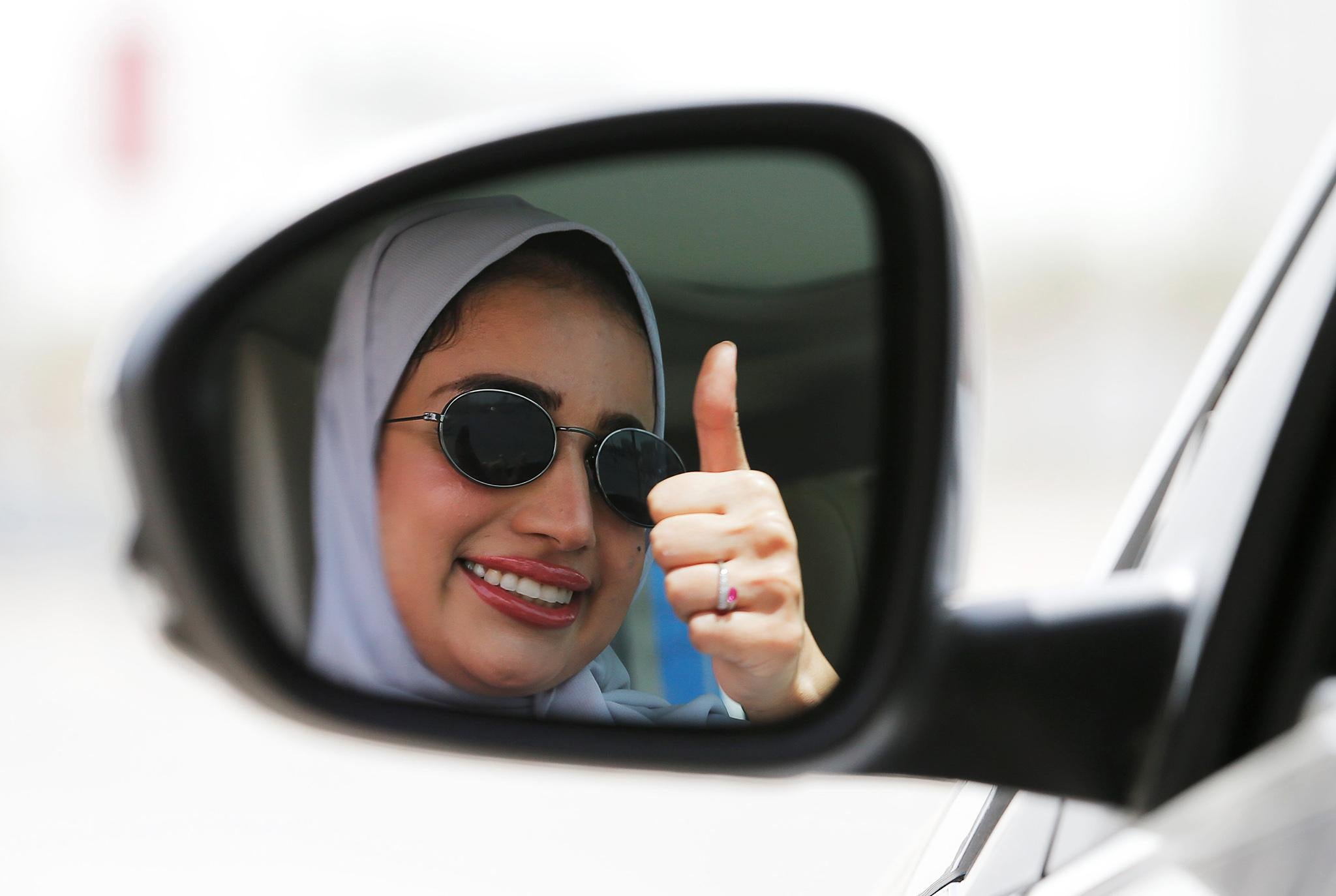 A Saudi woman gestures while driving in Dhahran, Saudi Arabia