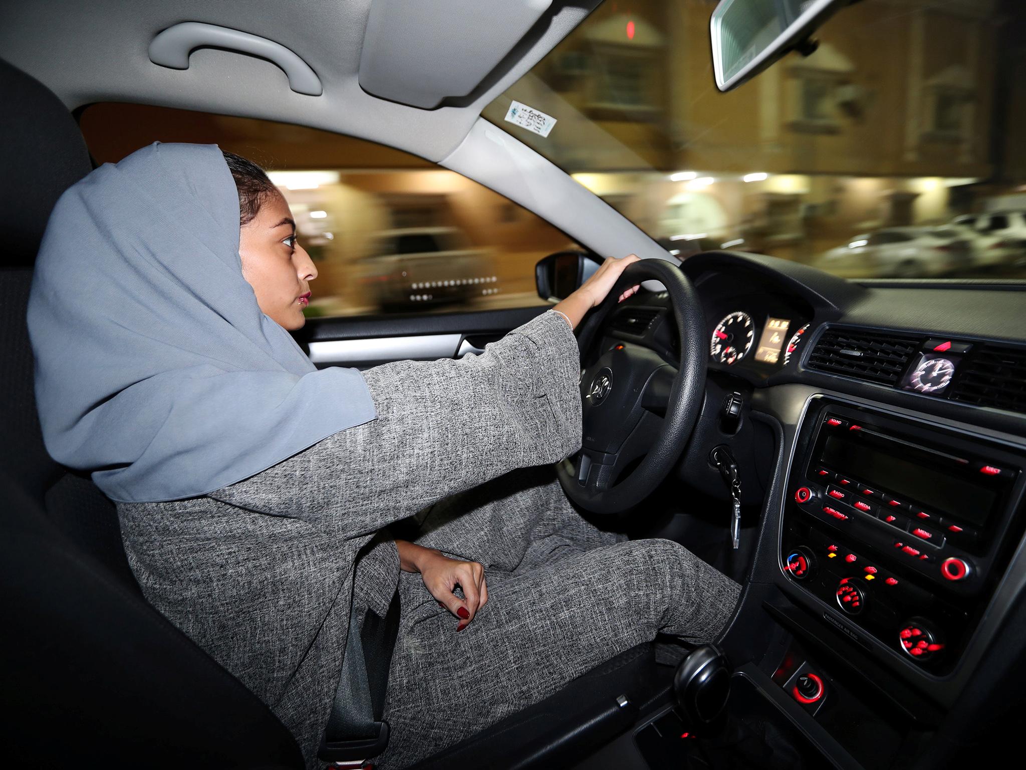 A Saudi woman drives at night in Al Khobar, Saudi Arabia