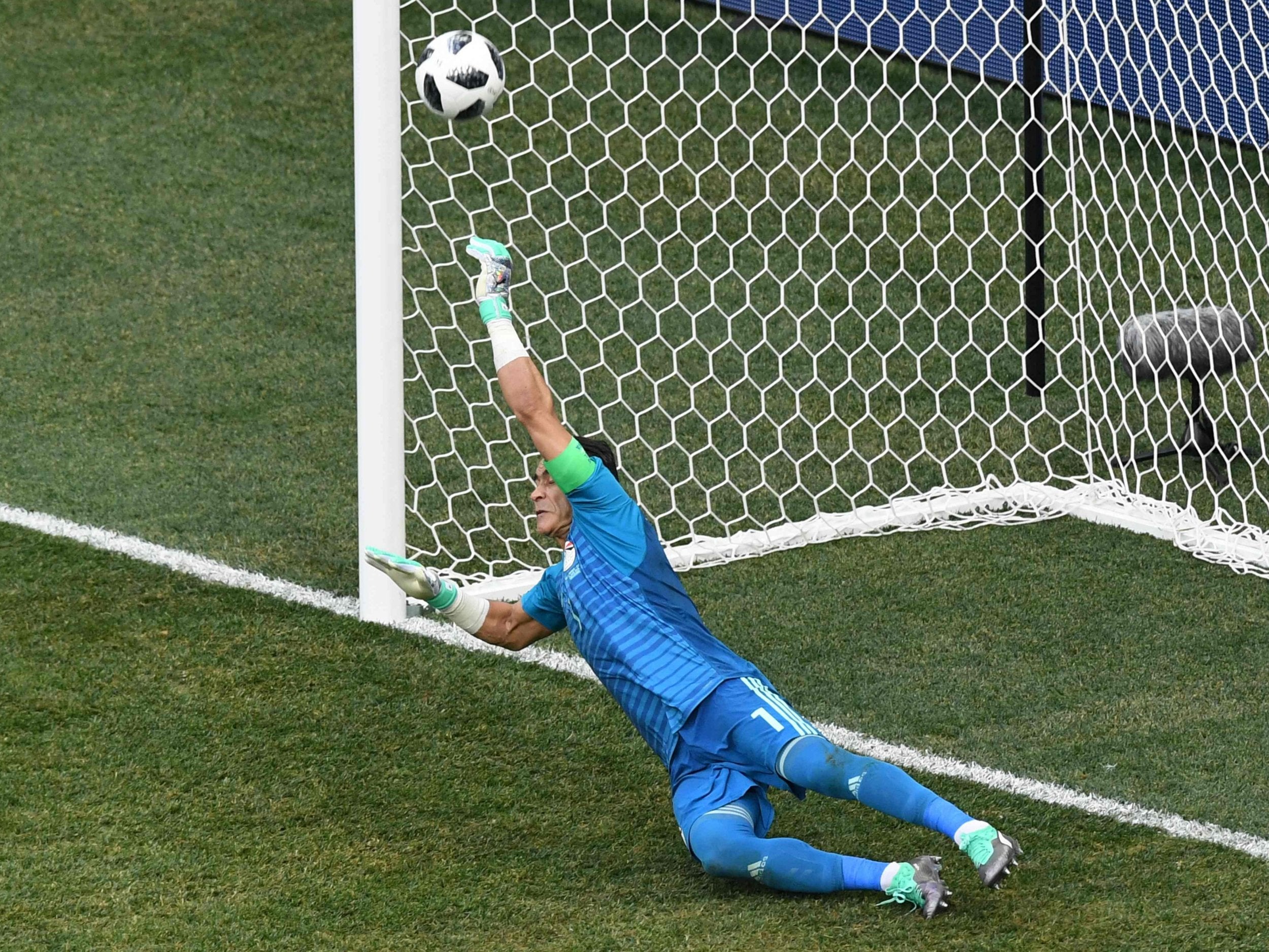 Egypt’s goalkeeper Essam El Hadary dives to save a penalty