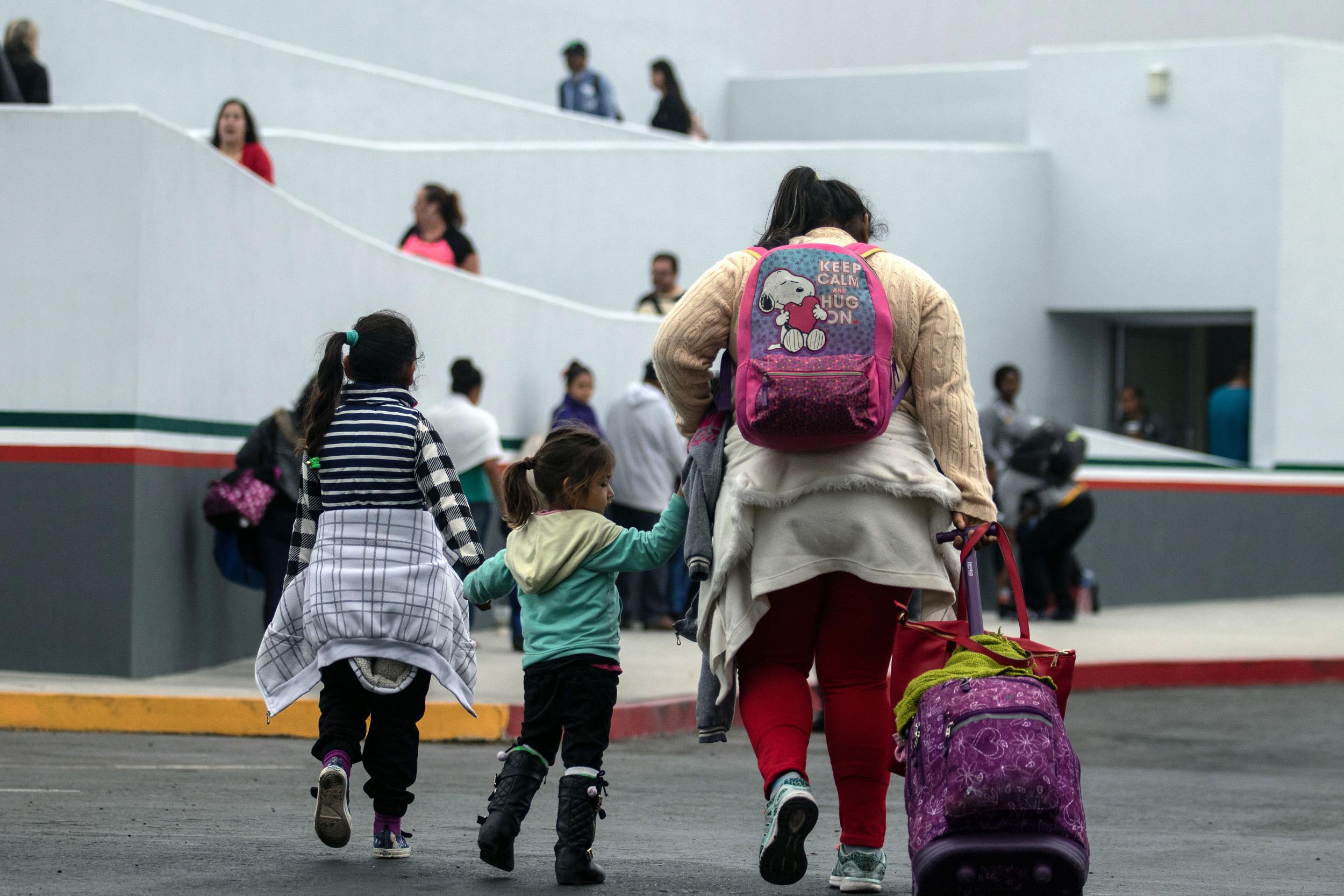 Migrants walk towards El Chaparral port of entry in Tijuana, Mexico, in the border with the United States